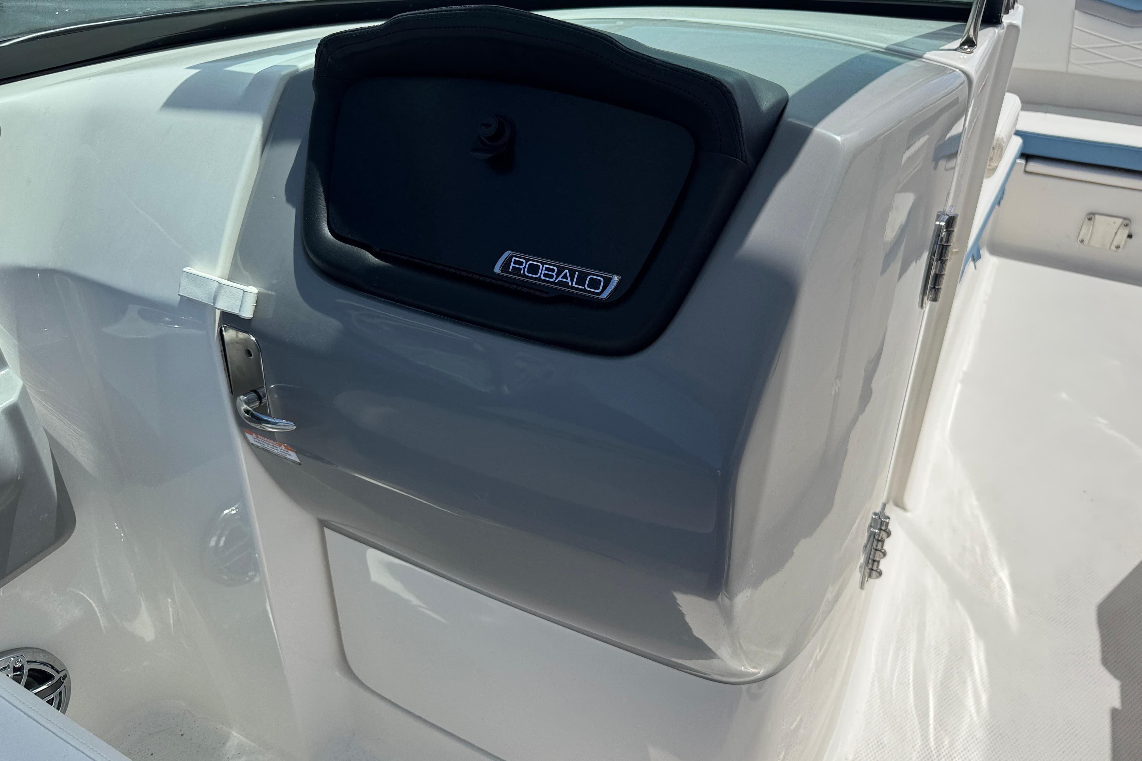 2026 Robalo R317 Dual Console boat interior with sleek design and storage compartment.