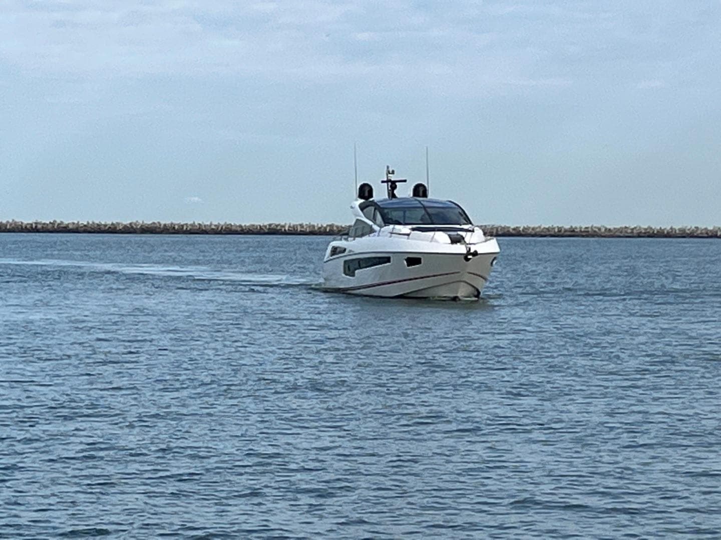 2014 Sunseeker 68 Predator yacht cruising on calm waters.