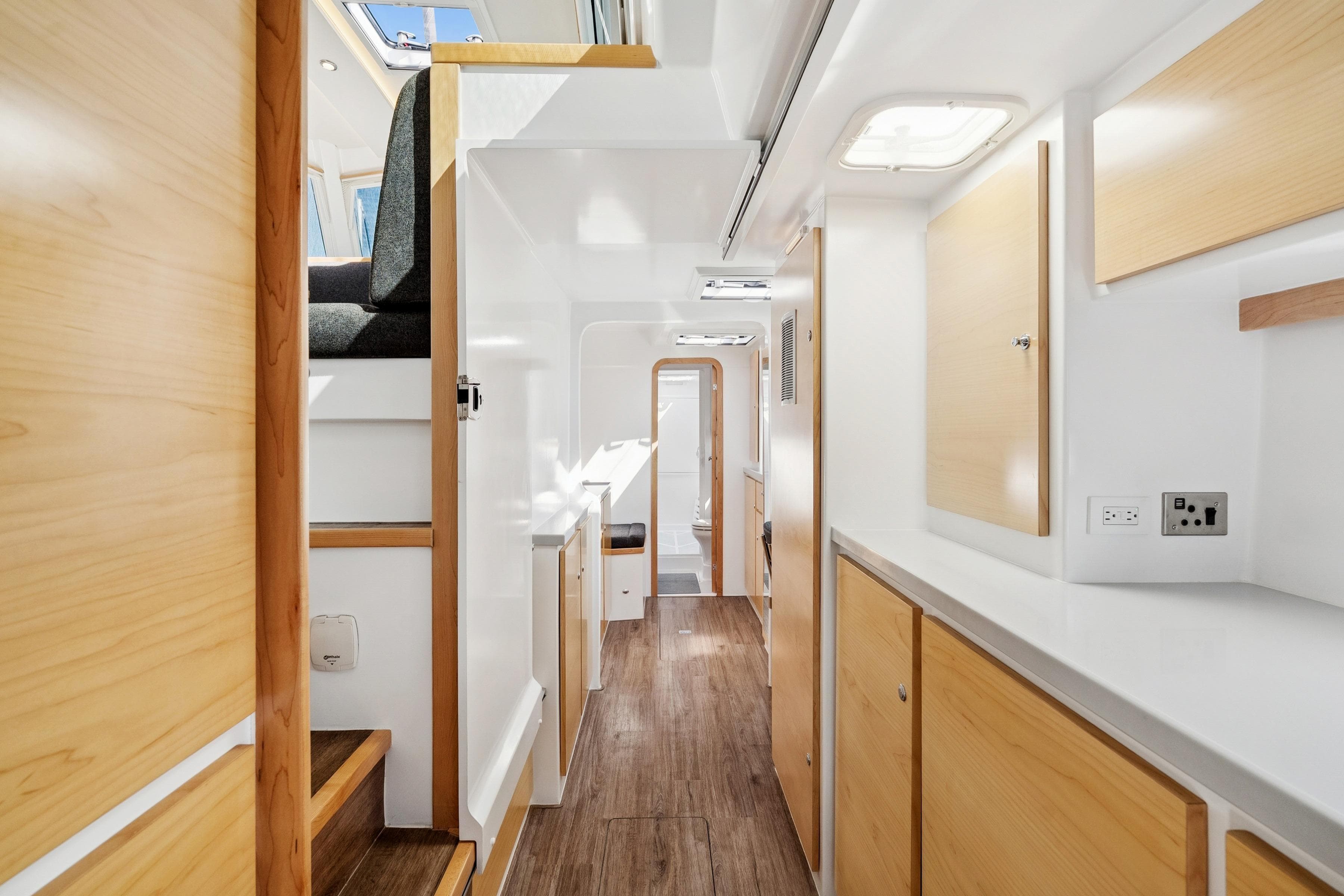 Modern interior of 2024 St Francis 460 yacht with wood accents and bright lighting.