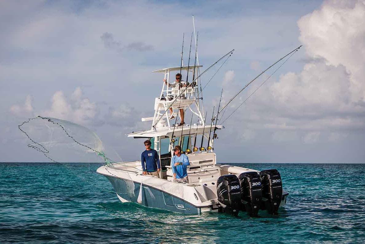 Manufacturer Provided Image: 2020 Boston Whaler 350 Outrage fishing boat with triple engines on open water.