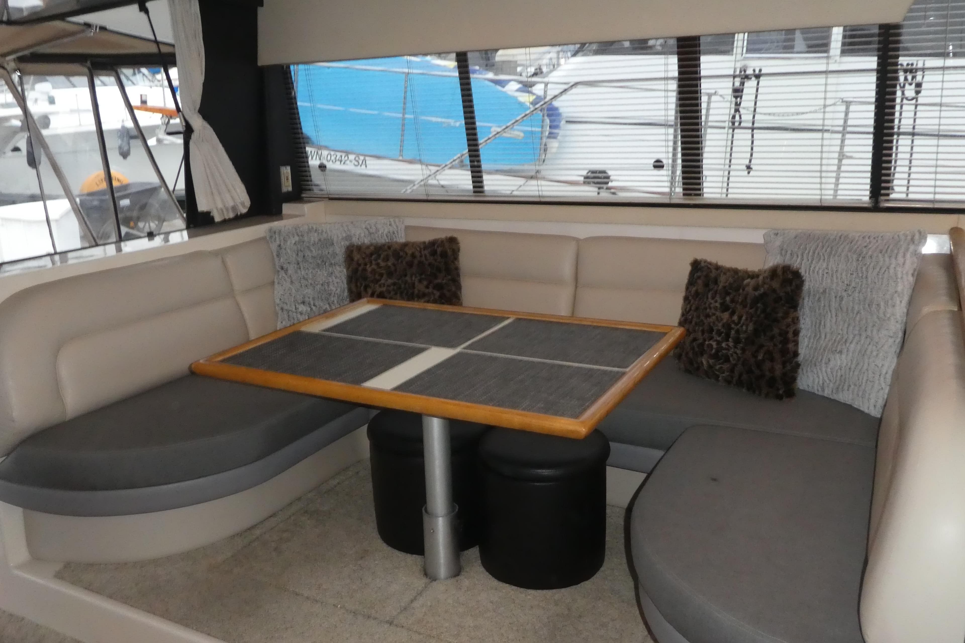 Interior of 1994 Bayliner 4388 Motor Yacht with cozy seating and table.