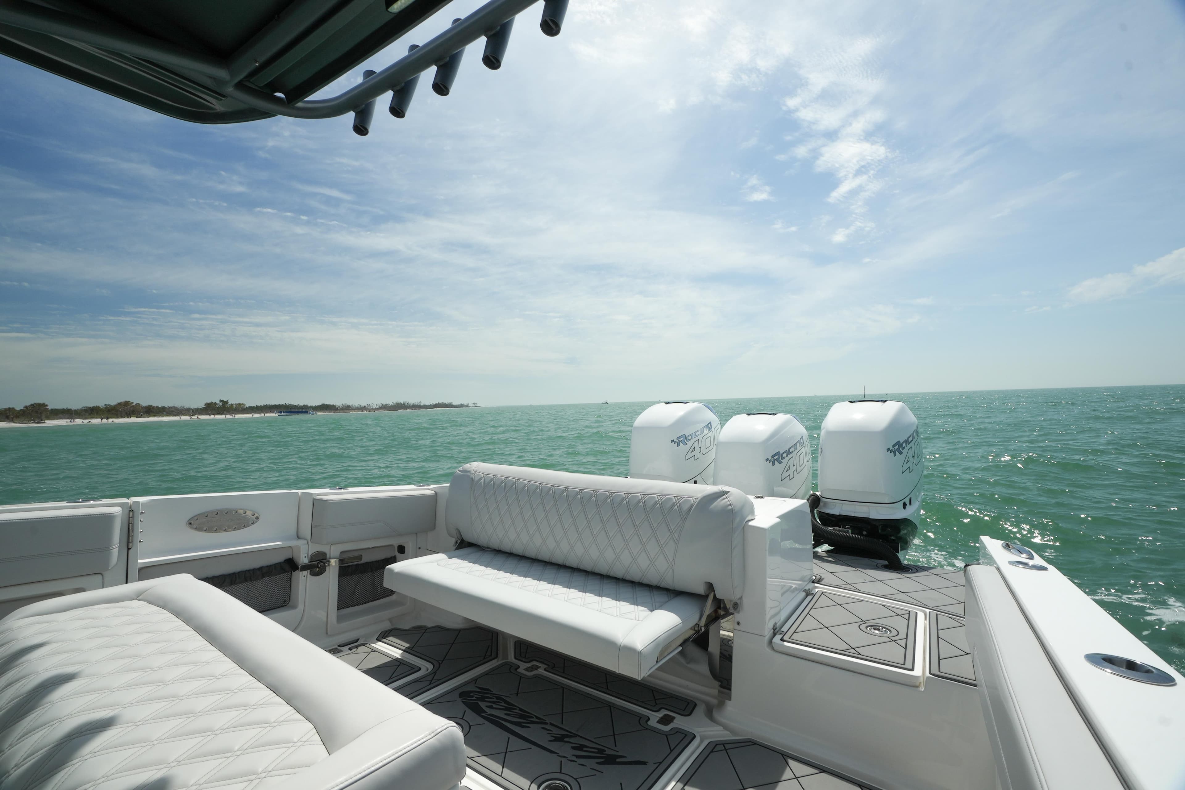 2020 Nor-Tech 390 Sport Center Console on open water, featuring luxurious seating and triple engines.