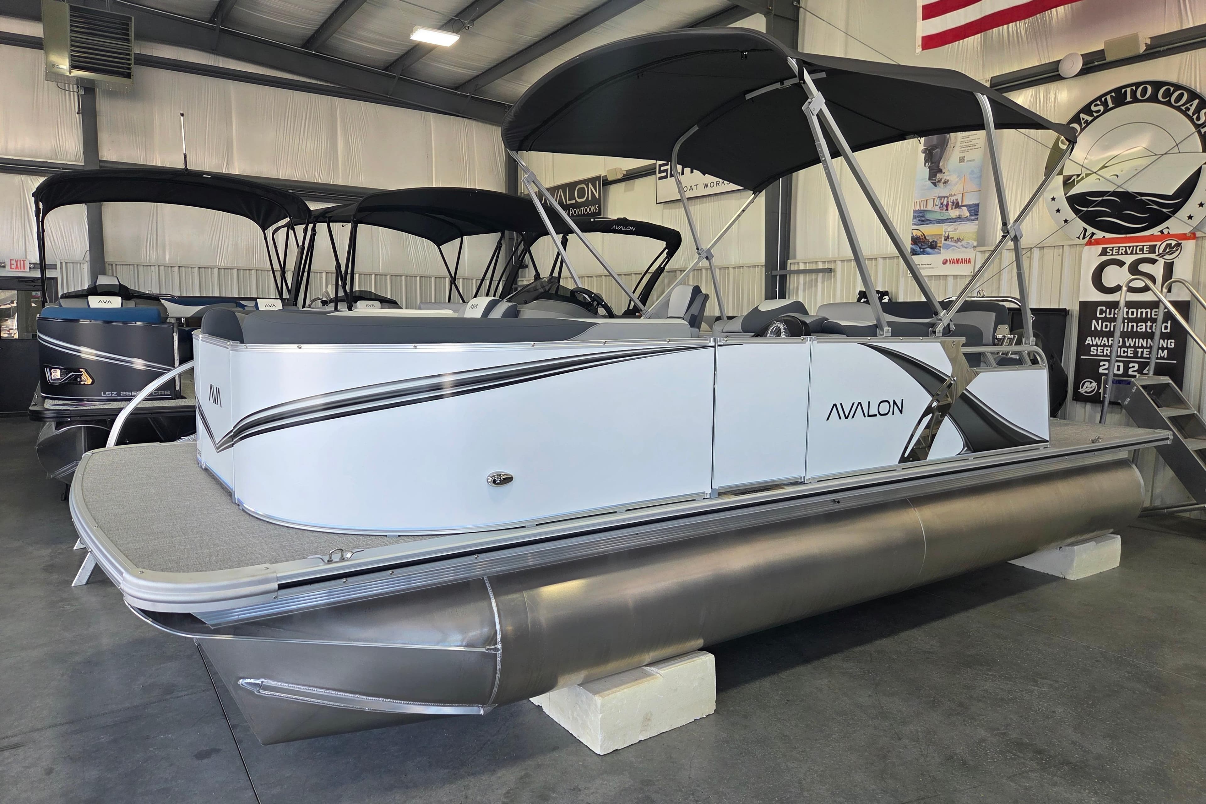 2026 Avalon LSZ 2185 Cruise Rear Bench pontoon boat displayed indoors.