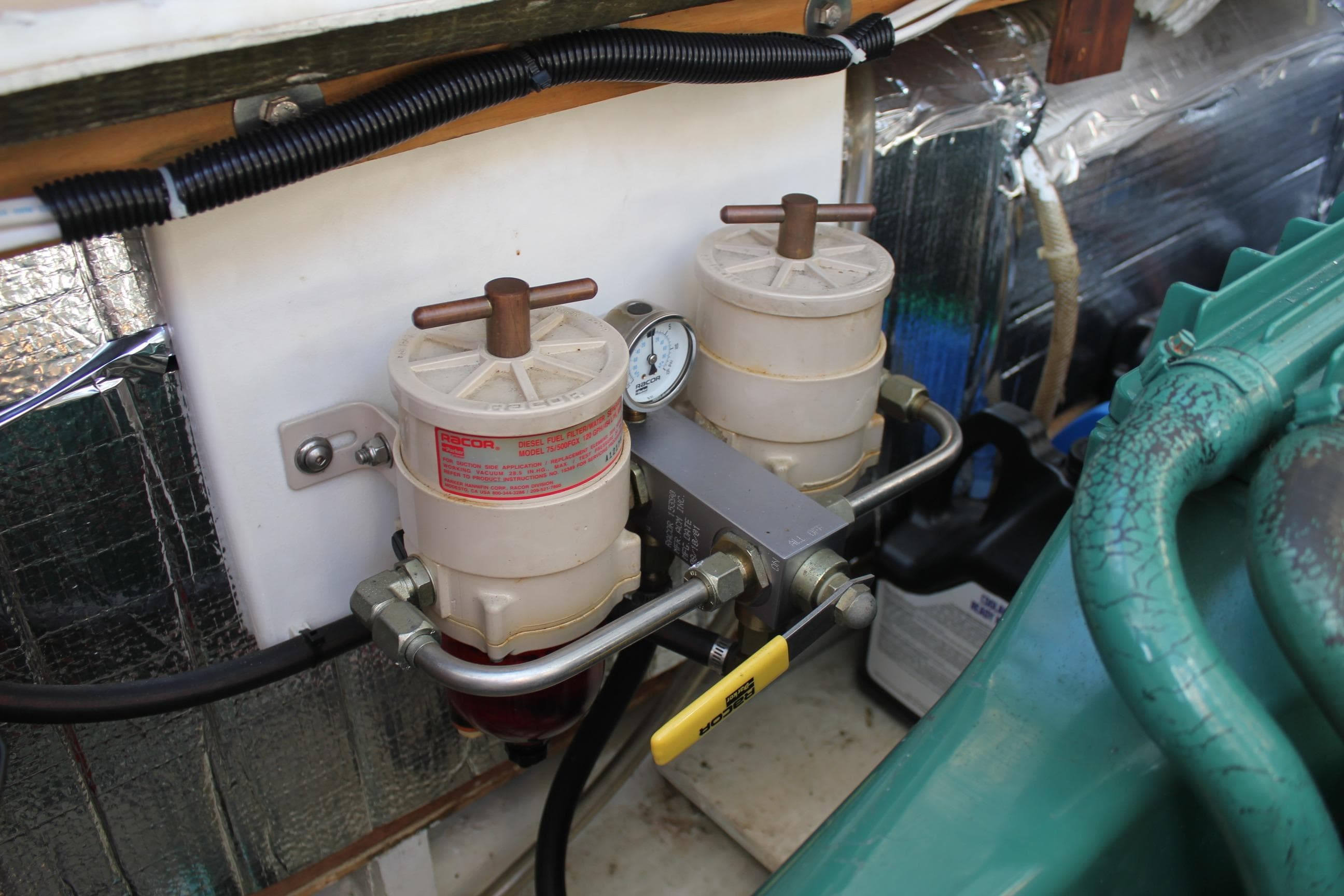 Fuel filter system in a 1988 Cape Dory 28 Hardtop boat engine compartment.