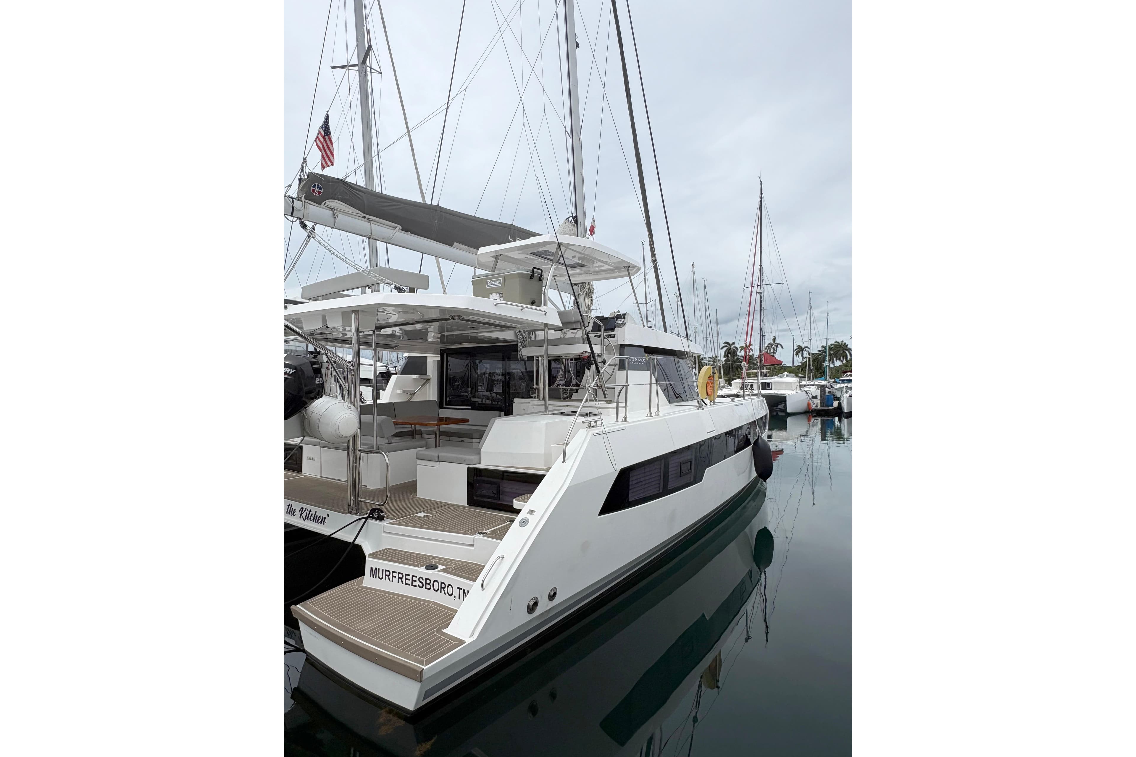 2025 Leopard 42 catamaran docked in a marina, featuring sleek design and spacious deck.