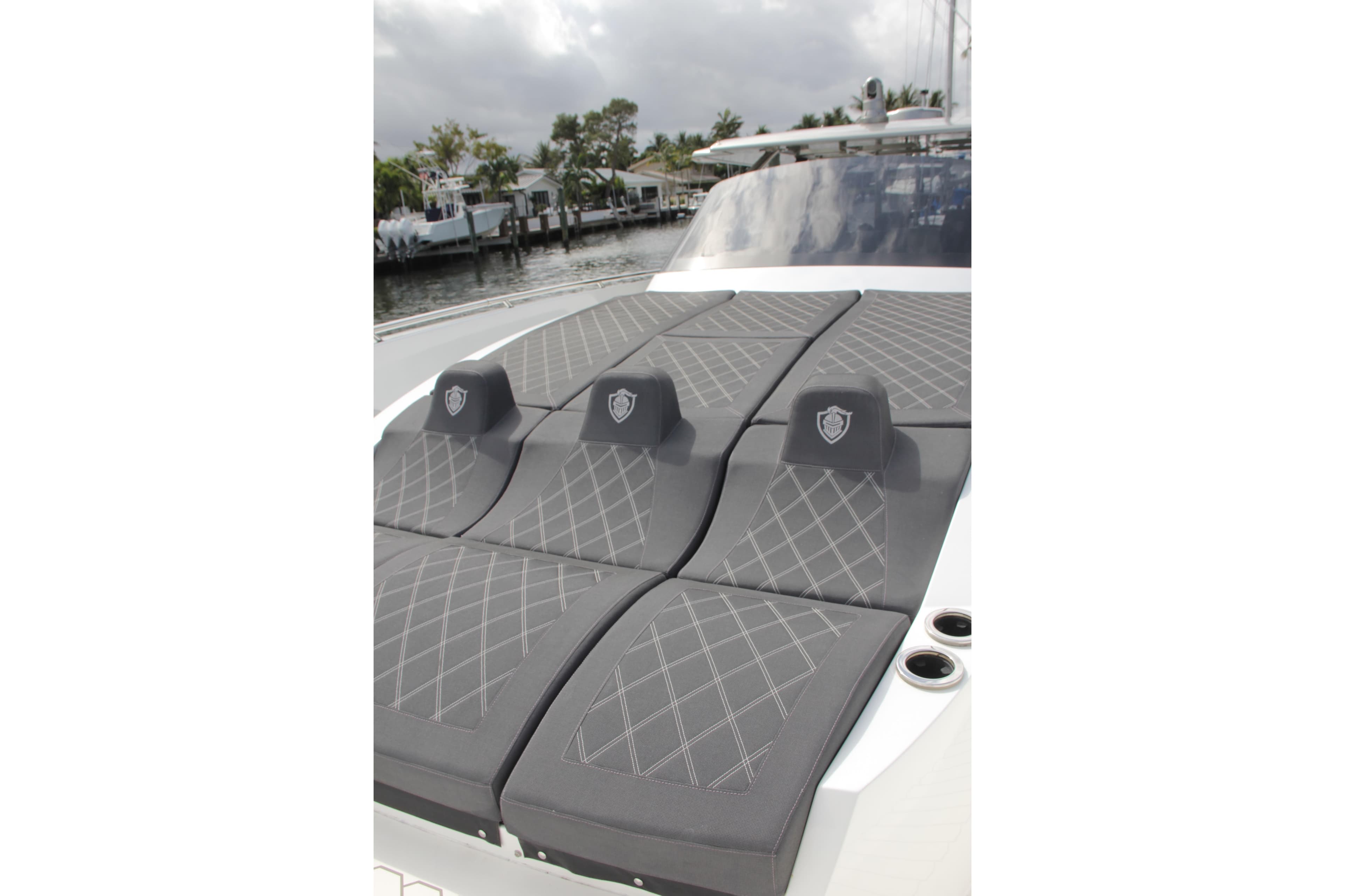 Luxurious seating on 2023 Canados 493 Gladiator yacht, featuring elegant gray upholstery.