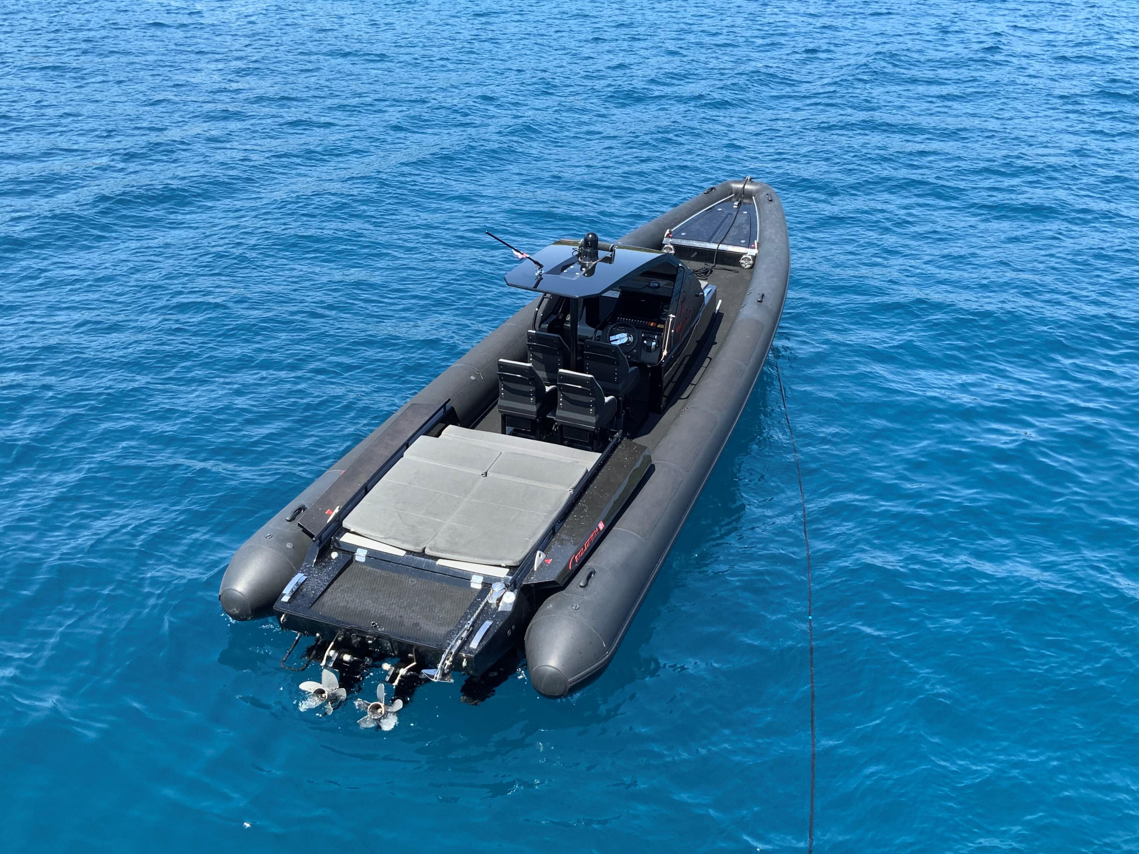 2016 Goldfish 38 Supersport boat on clear blue water, rear view.