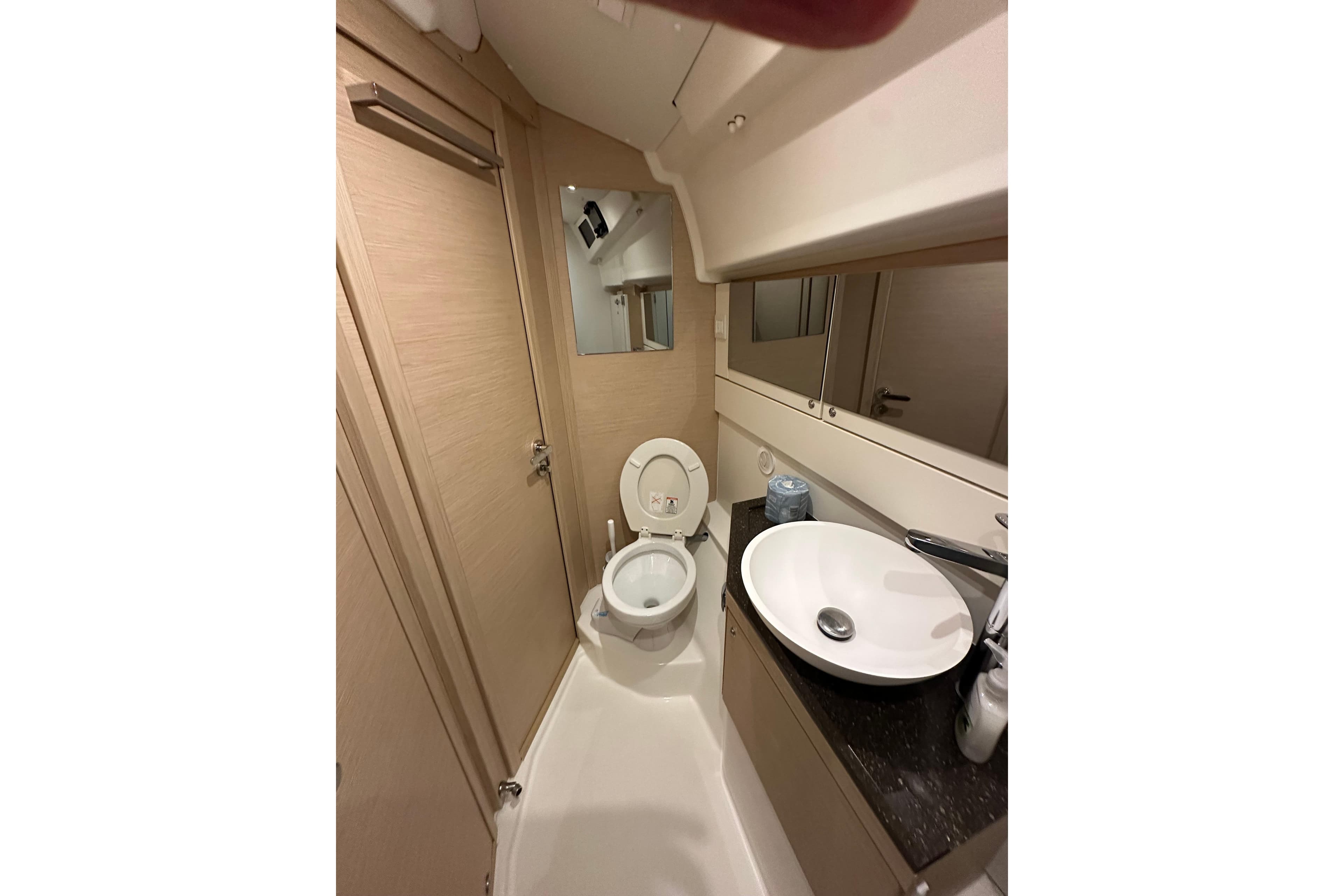 Bathroom interior of 2019 Jeanneau 51 yacht with modern fixtures and mirror.