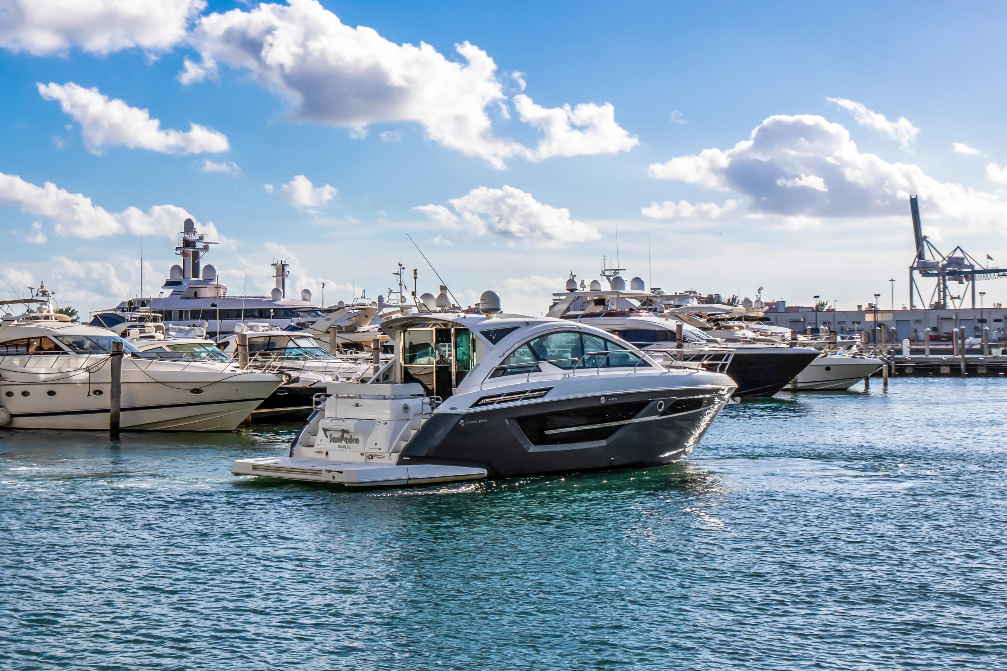 2019 Cruisers 50 Cantius yacht in a marina with other boats.