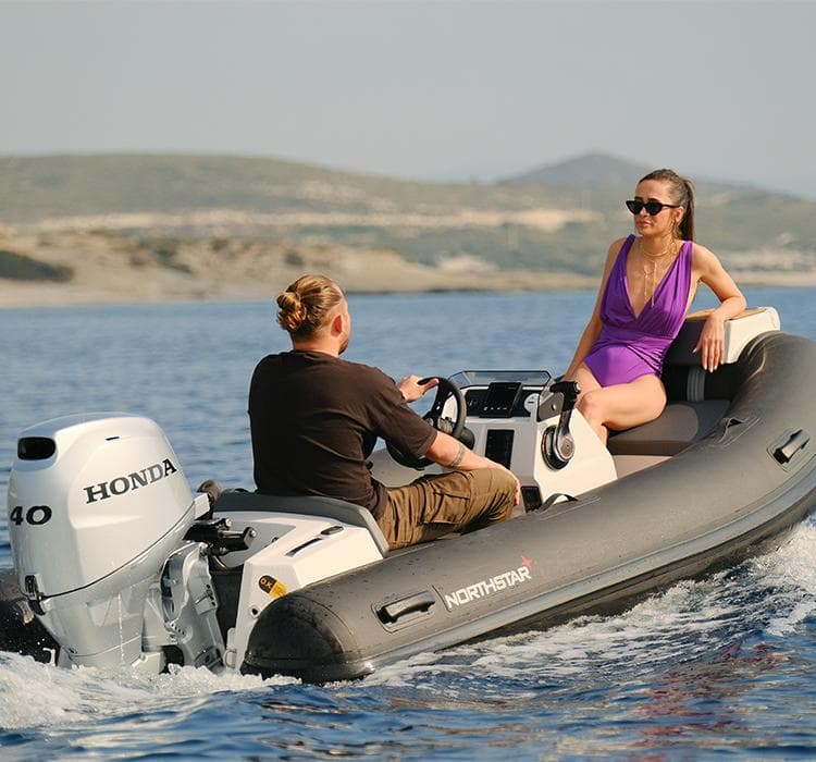 2022 Northstar Axis 3.4 boat with Honda engine, two people enjoying a ride on the water.