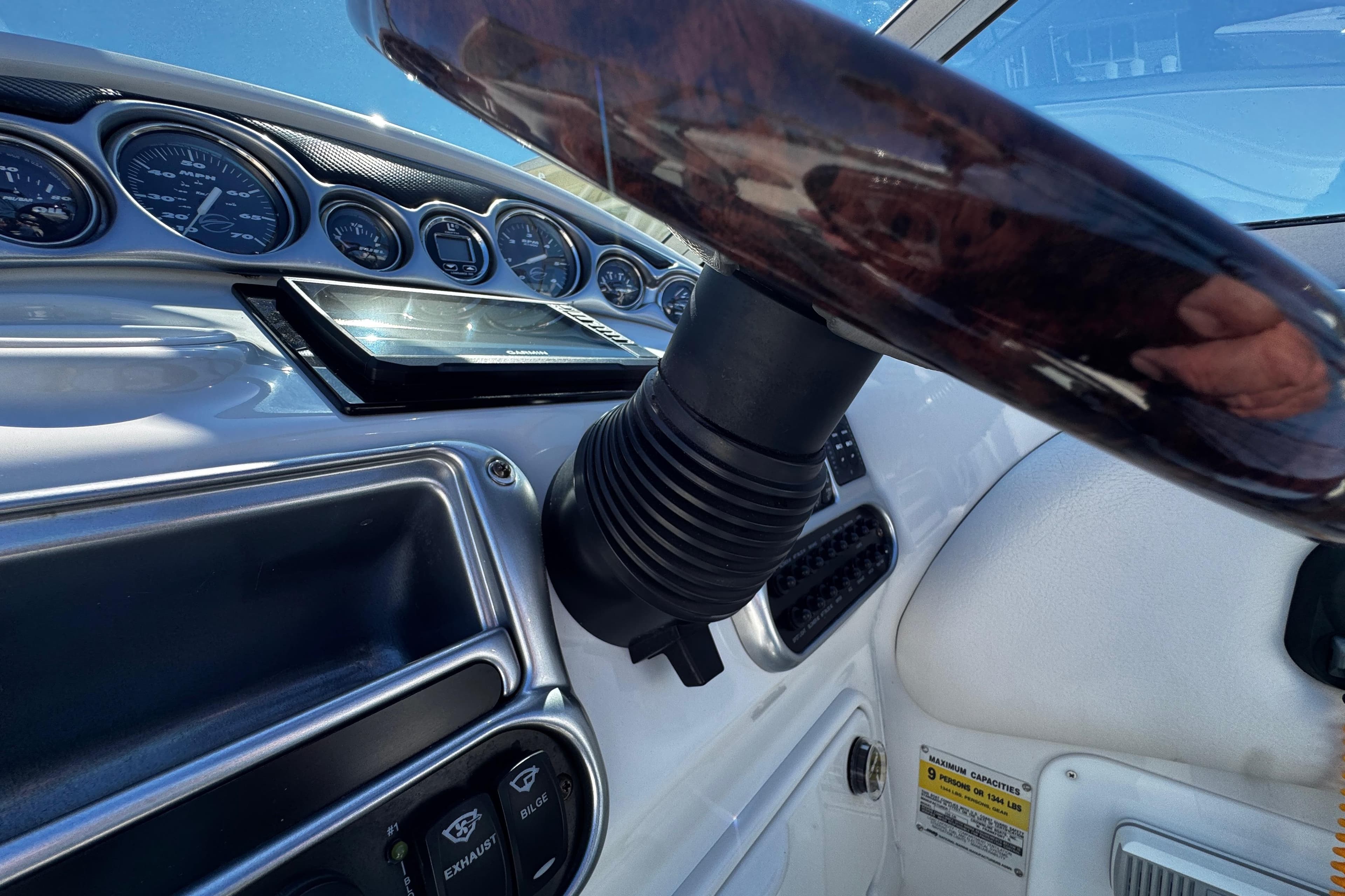 2004 Crownline 250 CR boat dashboard with gauges and steering wheel.