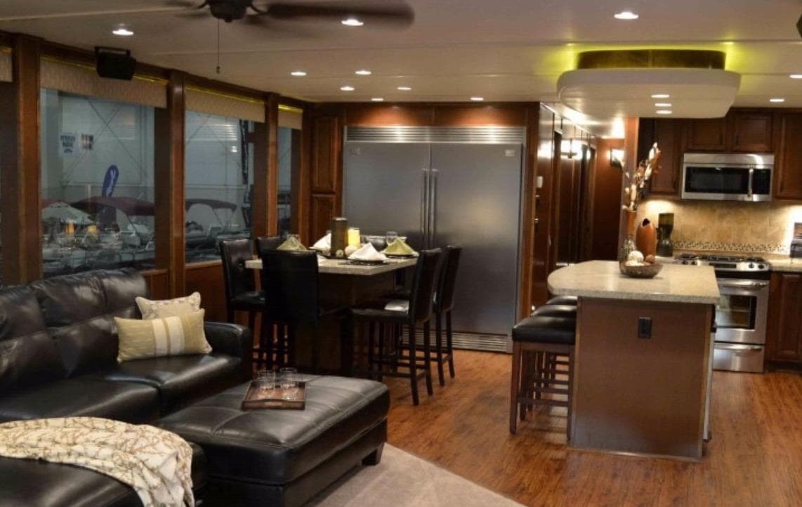 Luxurious interior of 2012 Bravada Ho'okipa Trip 13 houseboat with modern kitchen and seating area.