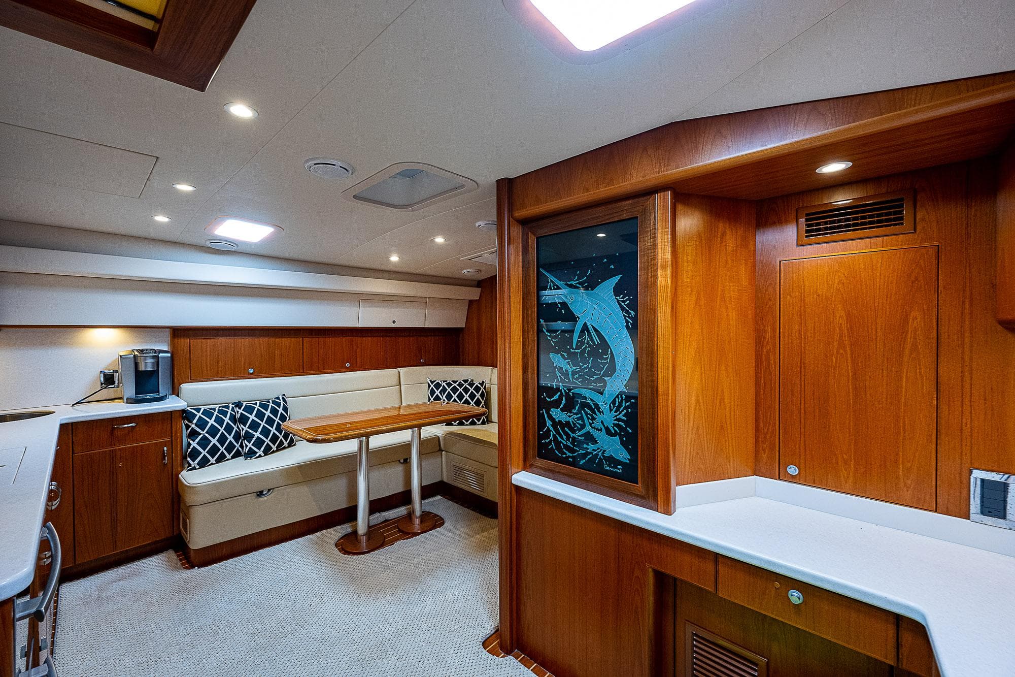 Luxurious interior of 2012 Cabo 44 HTX yacht with wood finish and seating area.