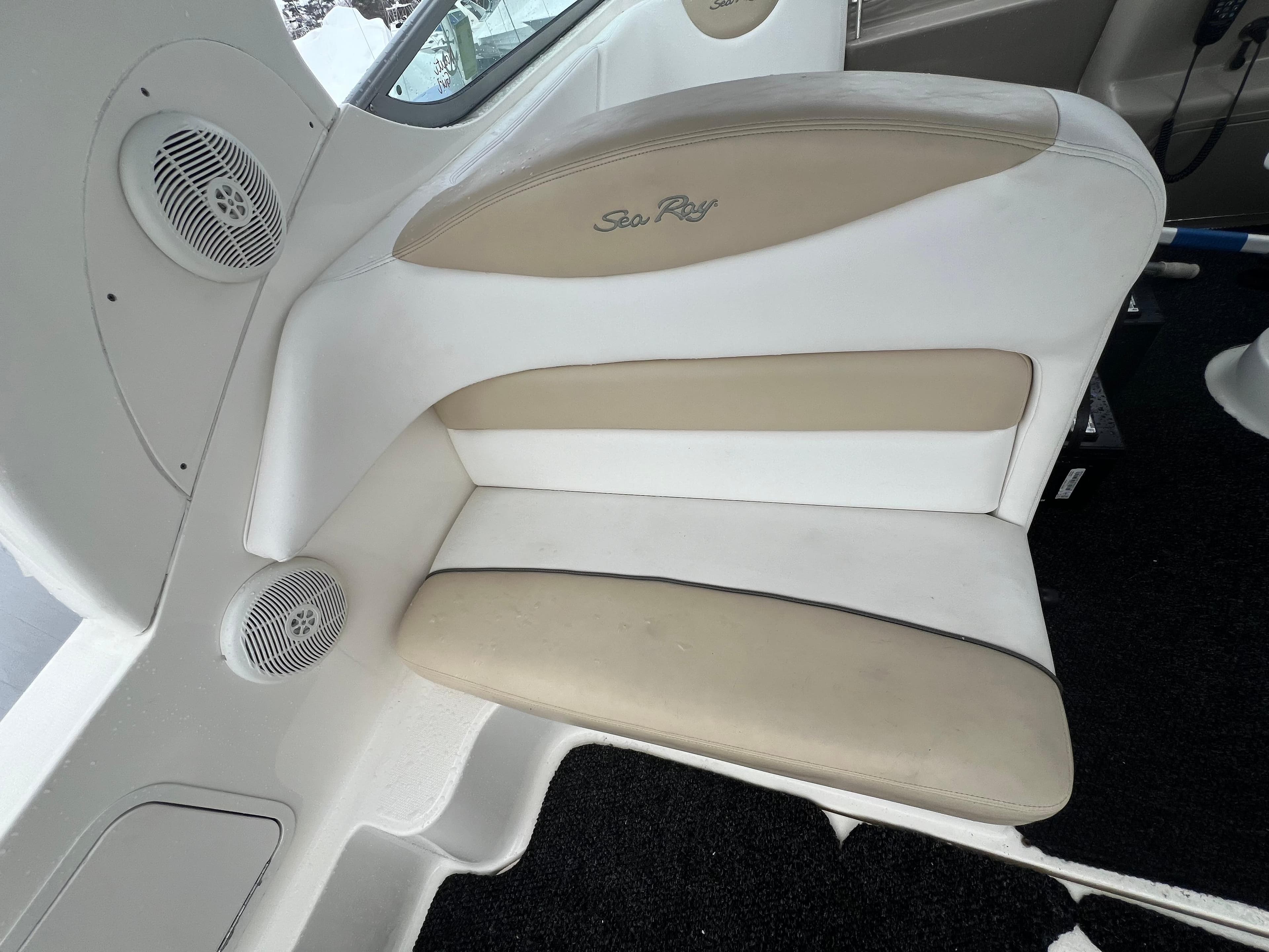 2008 Sea Ray 280 Sundancer boat seat with beige and white upholstery.