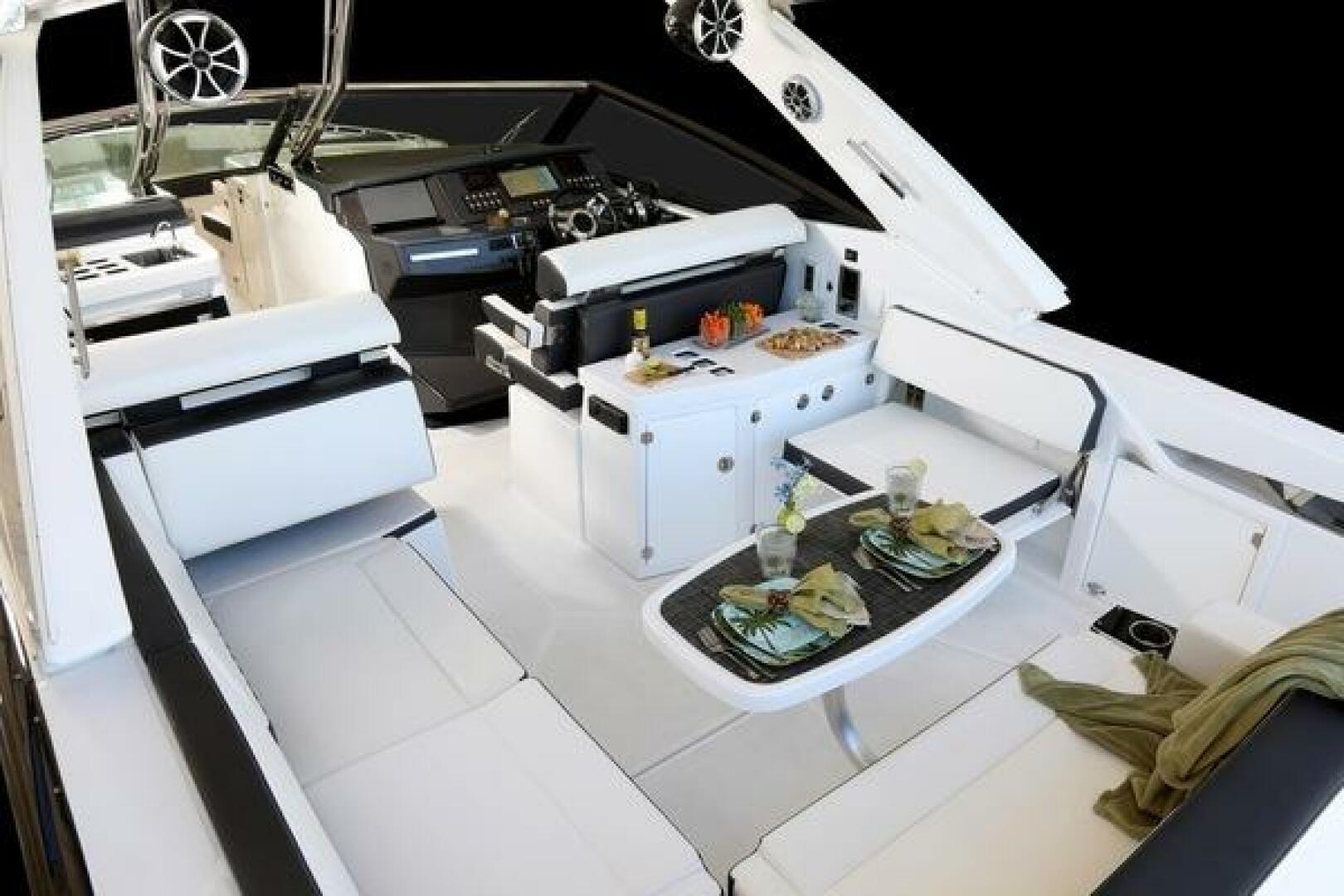 Luxurious interior of 2025 Monterey 385SS boat with elegant seating and dining area.