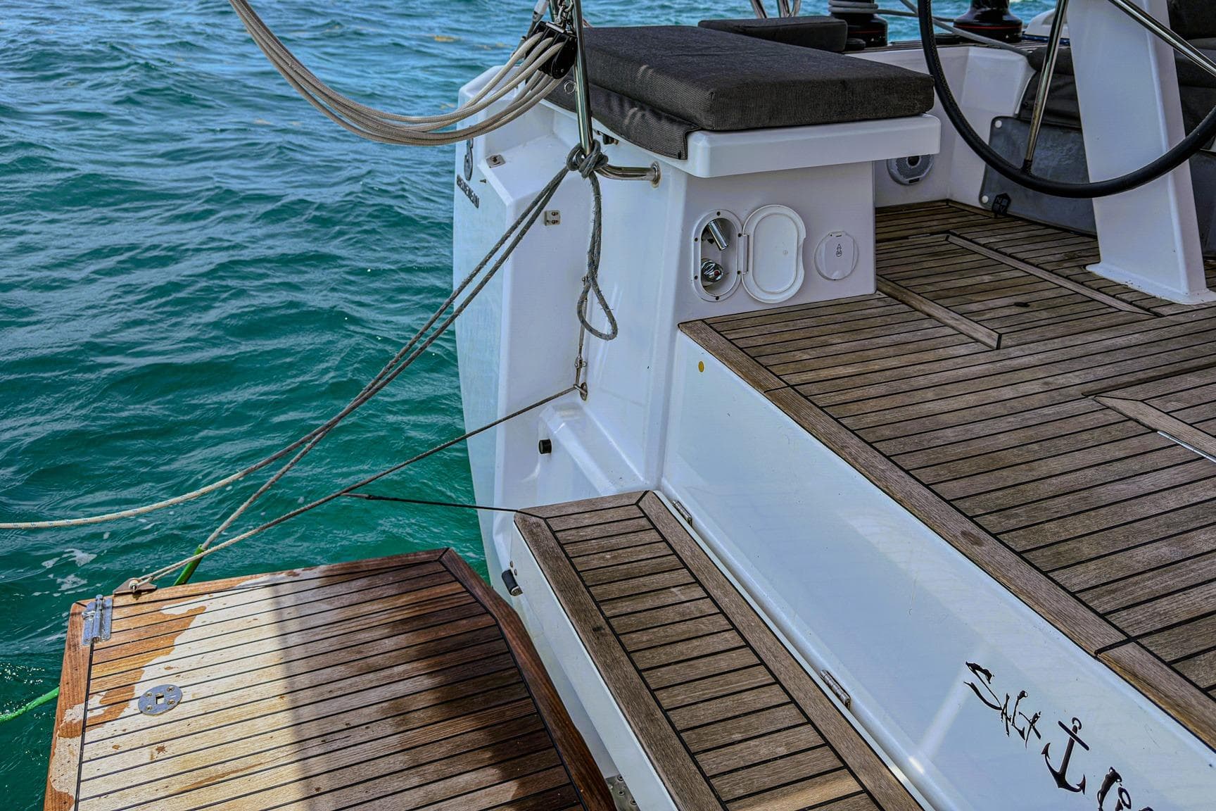 Beneteau Oceanis 46.1 yacht deck, 2020 model, with teak flooring and ocean backdrop.