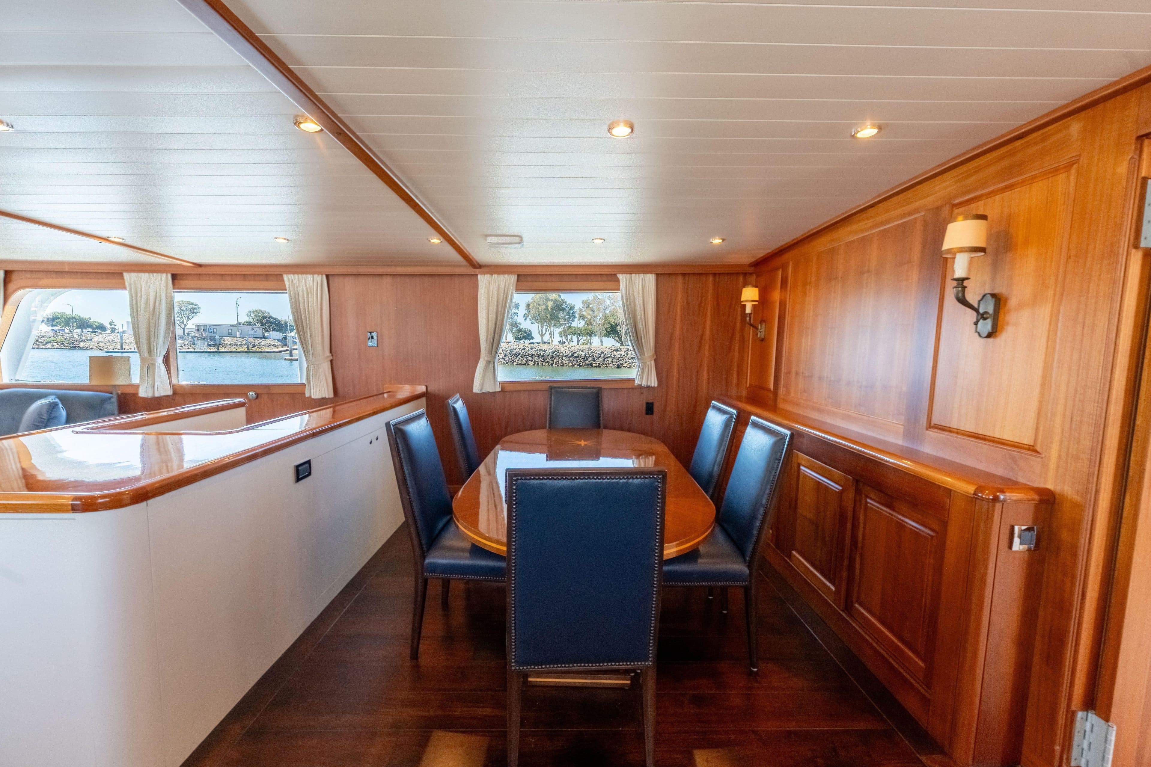 Luxurious 1969 Custom Hargrave yacht interior with elegant wood paneling and dining area.
