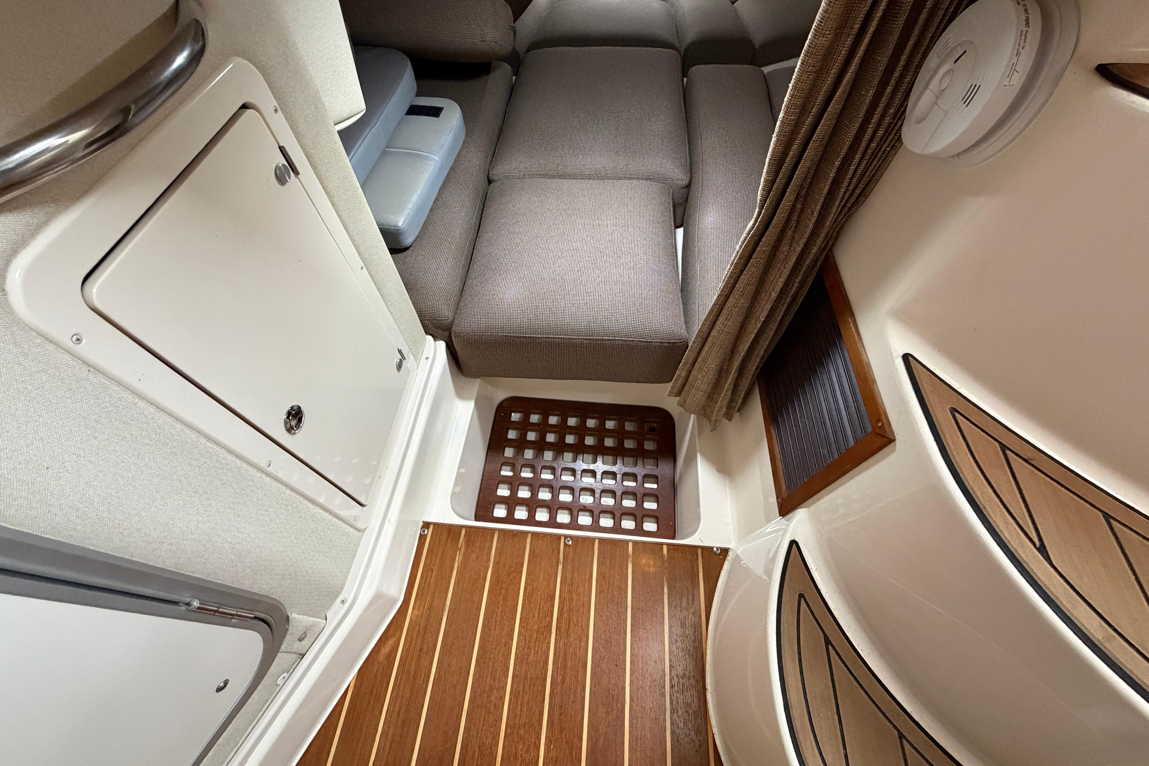 2004 Grady-White Express 330 cabin interior with seating and wood flooring.