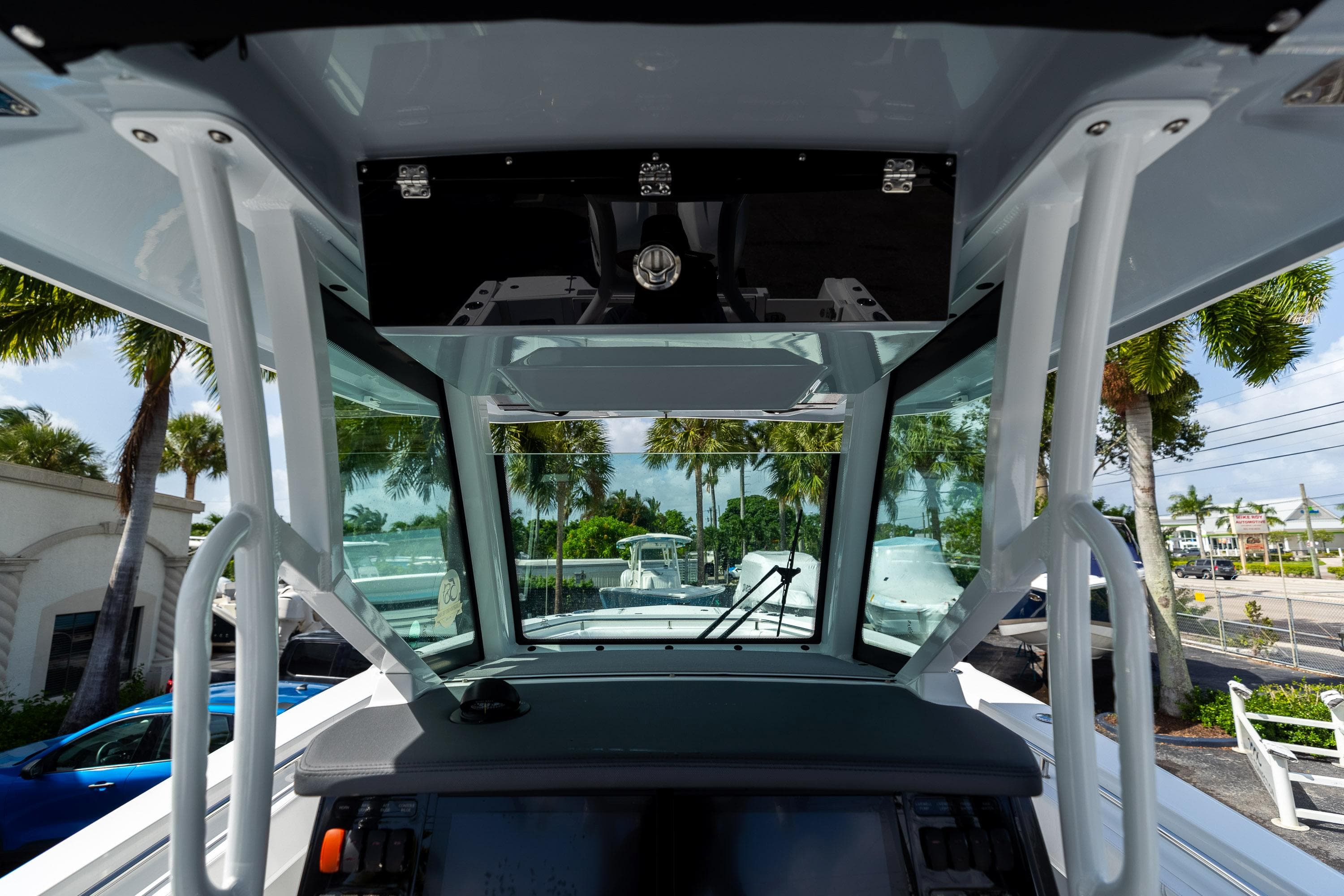 2023 Blackfin 302CC boat interior with modern dashboard and tropical background.