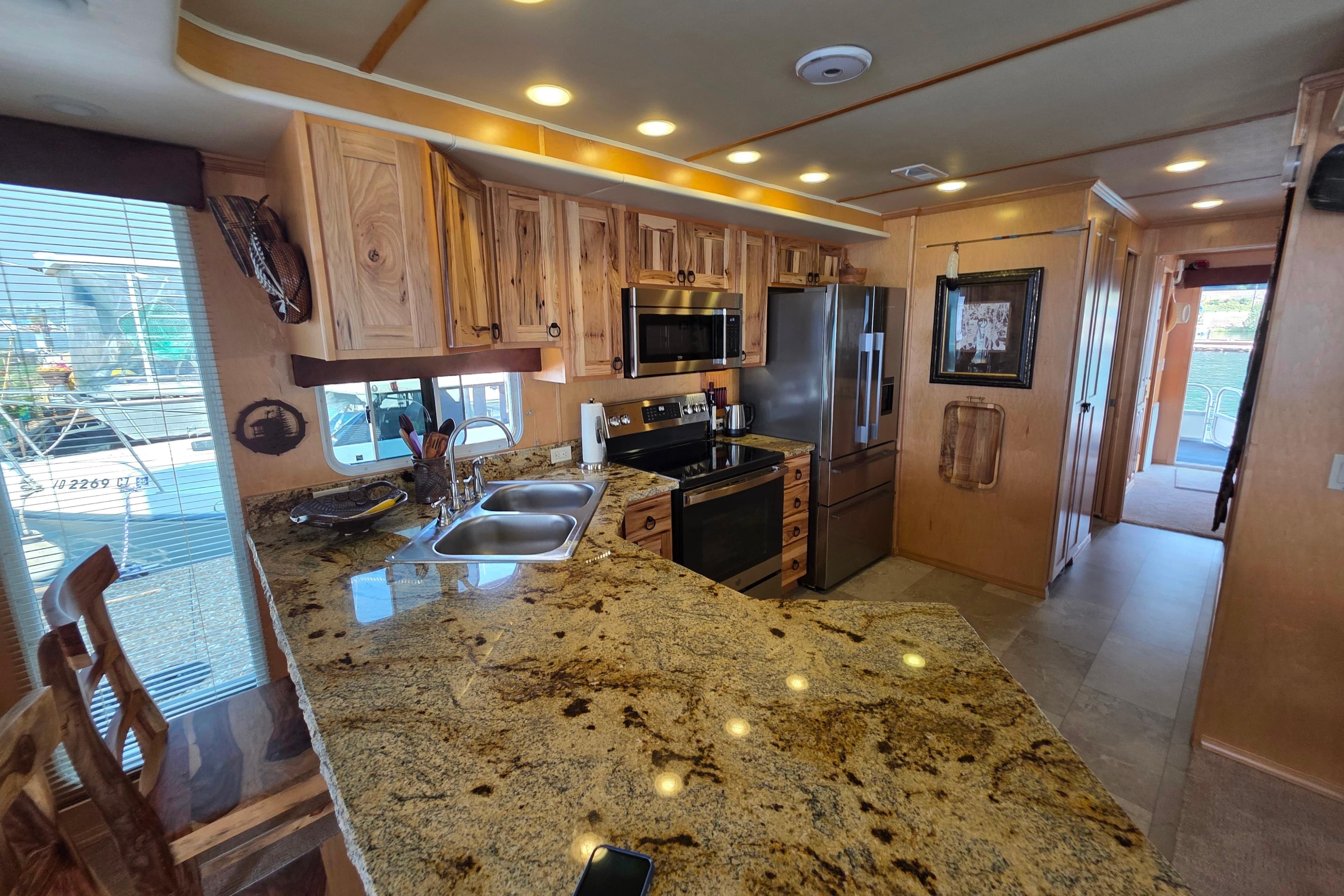 Luxurious 2015 Sailabration 64 kitchen with granite countertops and modern appliances.