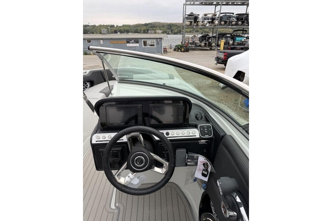 2026 Crownline 288 SS boat dashboard with steering wheel and control panel.