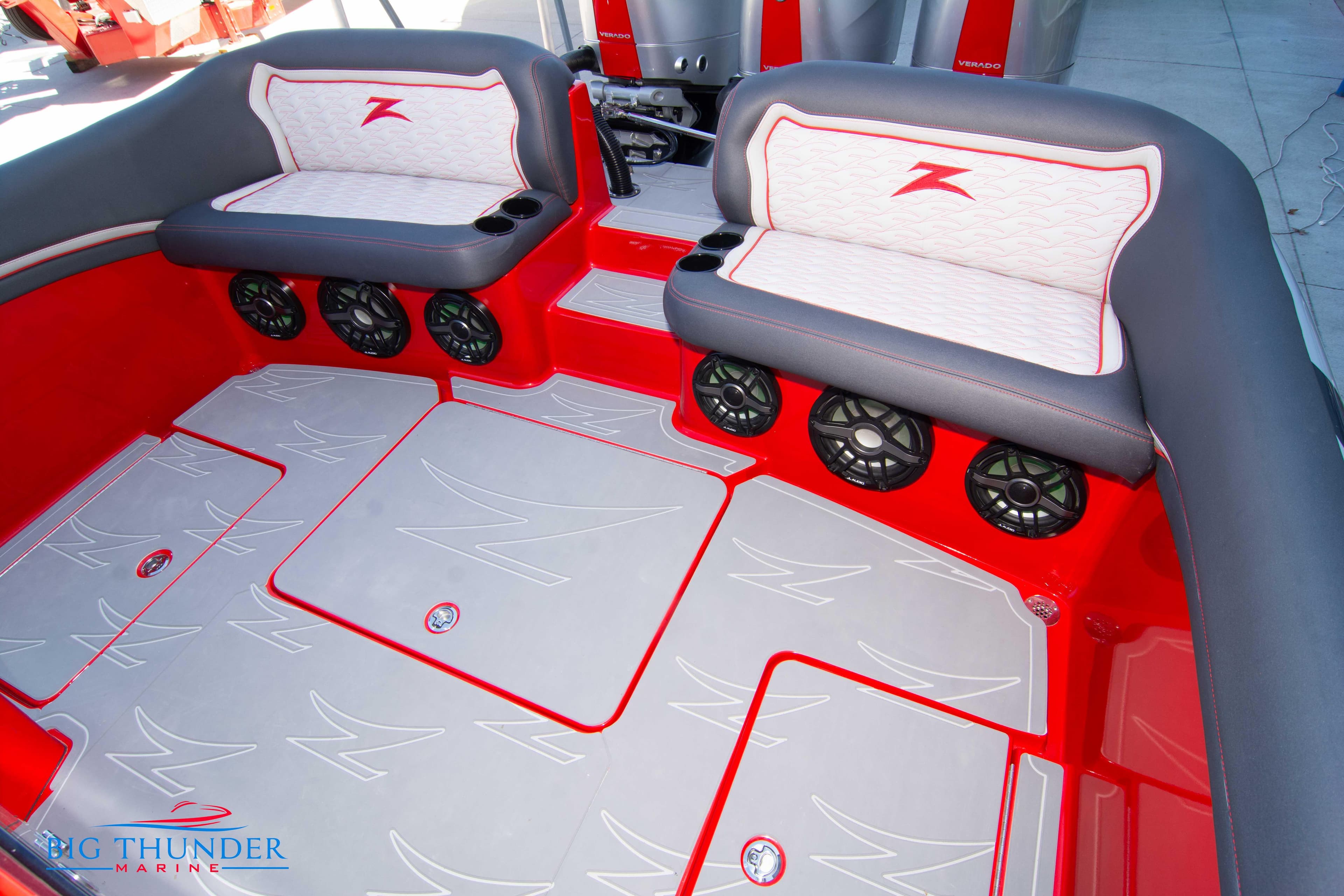 2024 Donzi 39 VRZ boat interior with red and gray seating and multiple speakers.