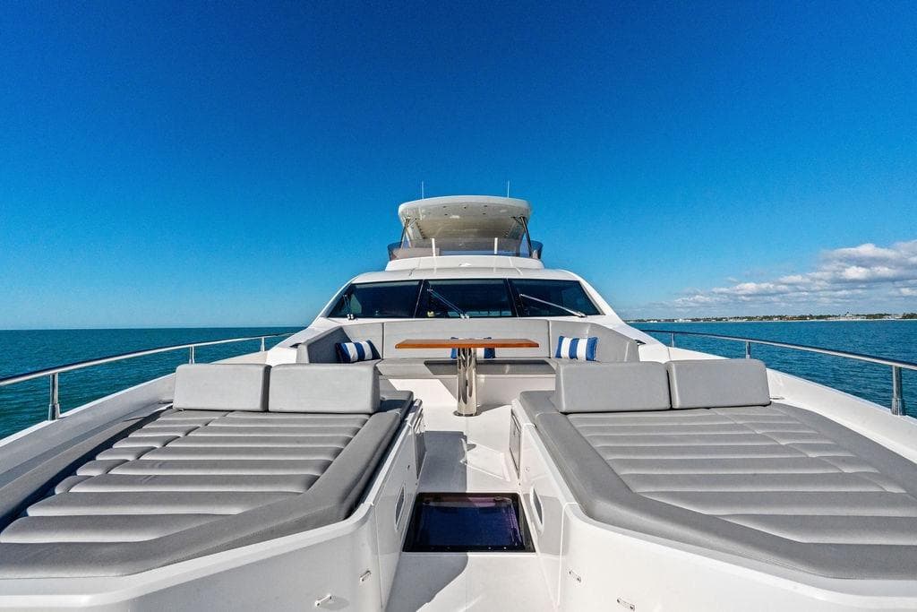 Luxurious 2019 Sunseeker 76 Yacht with sun loungers on open sea.