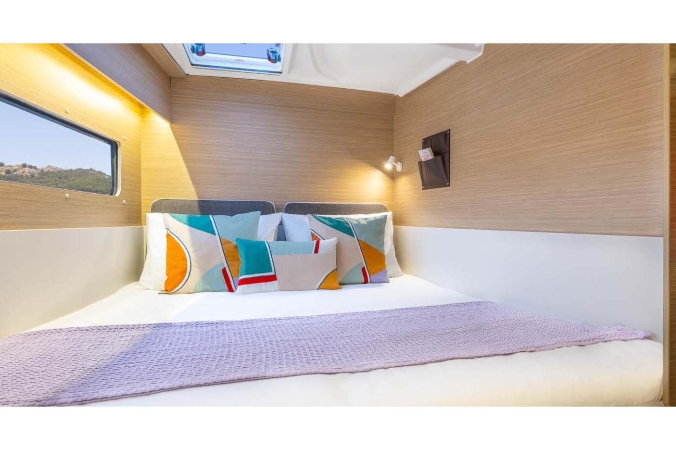 Manufacturer Provided Image: Luxurious cabin interior of 2026 Lagoon 38 yacht with modern bedding and natural light.