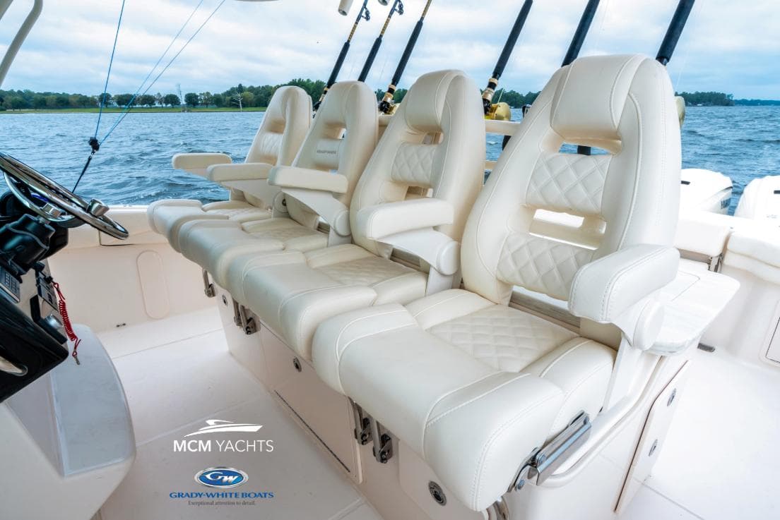 Luxurious seating on 2025 Grady-White Canyon 386 yacht, featuring elegant white upholstery.