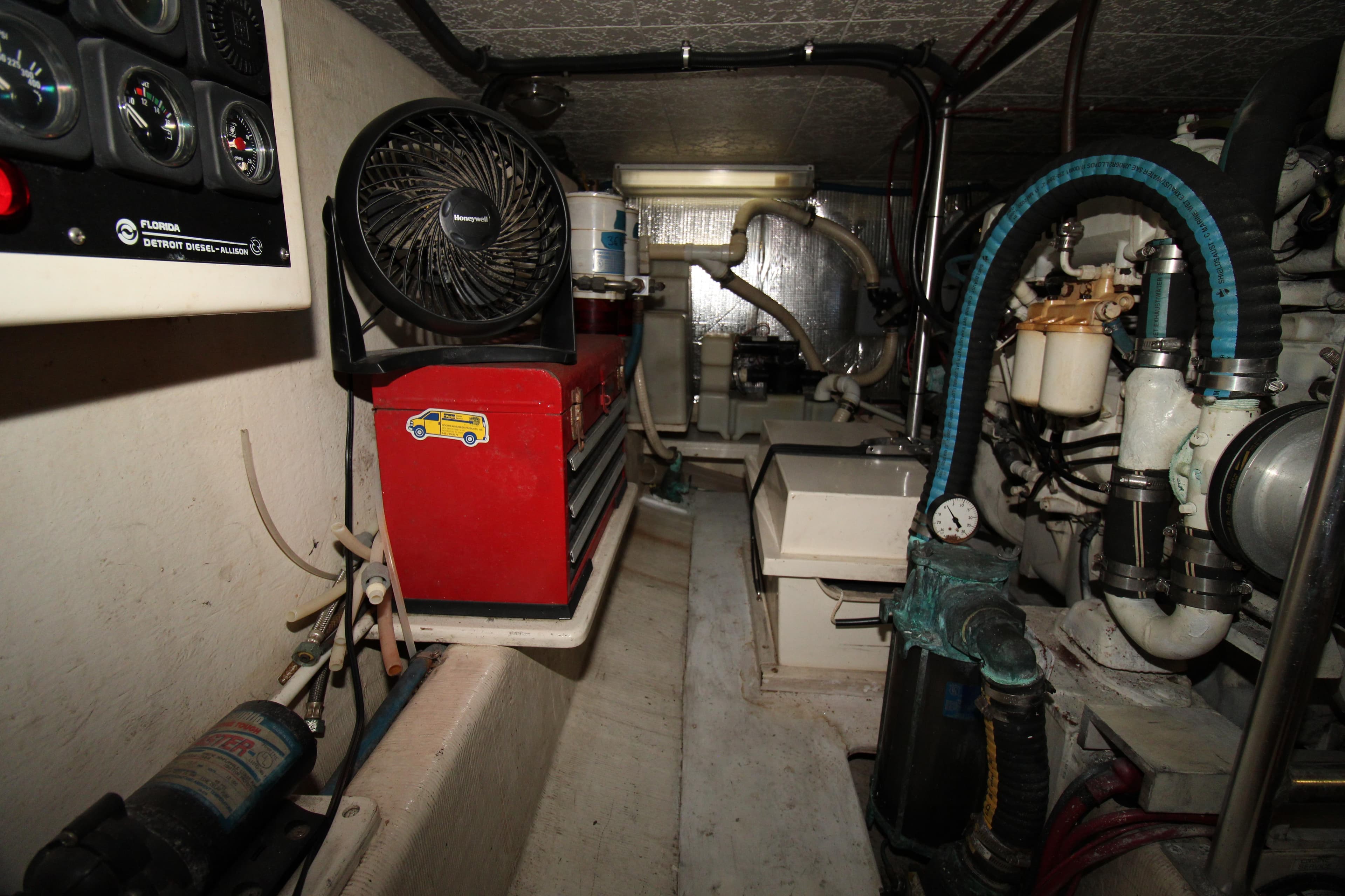 Engine room of a 2000 Ricker 42 Classic boat with tools and equipment.