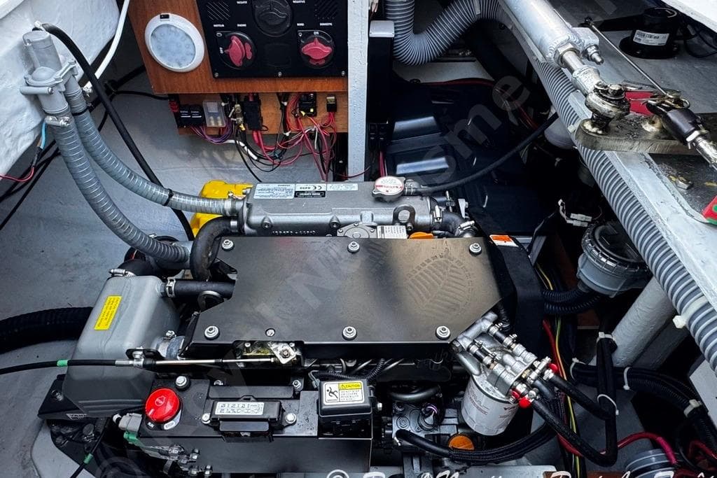 Engine compartment of a 2018 Lagoon 42 catamaran, showcasing mechanical components and wiring.