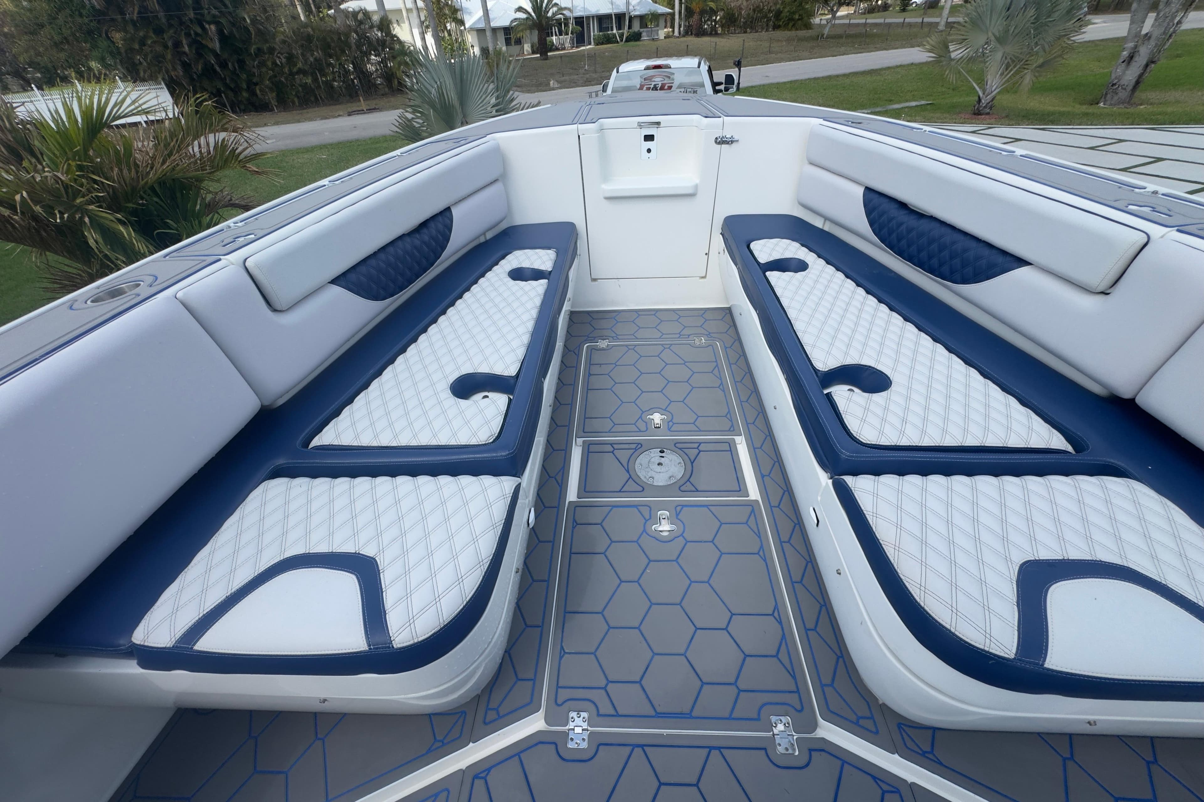 2007 Intrepid 370 Center Console boat interior with blue and white seating and geometric flooring.