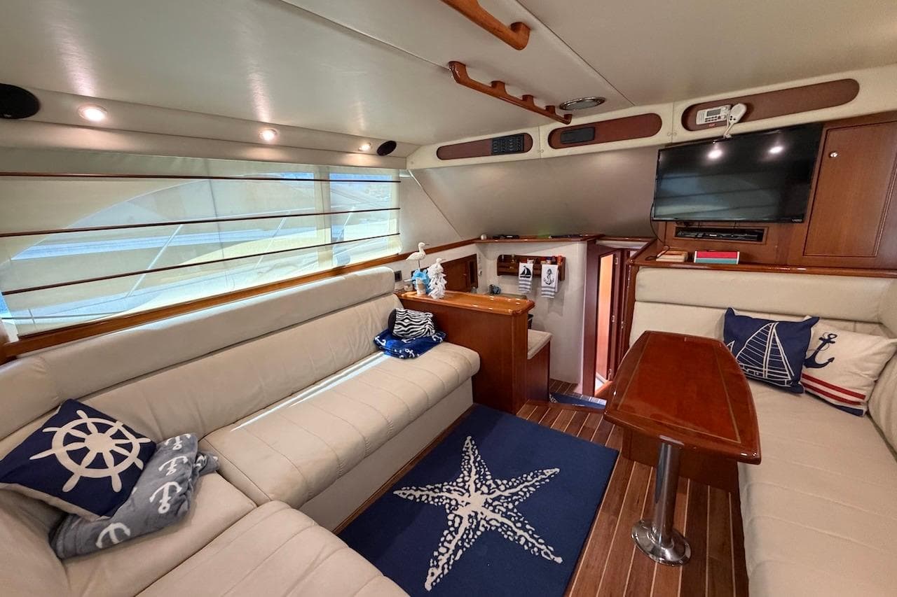 Luxurious interior of 2005 Riviera 37 Flybridge yacht with nautical-themed decor.