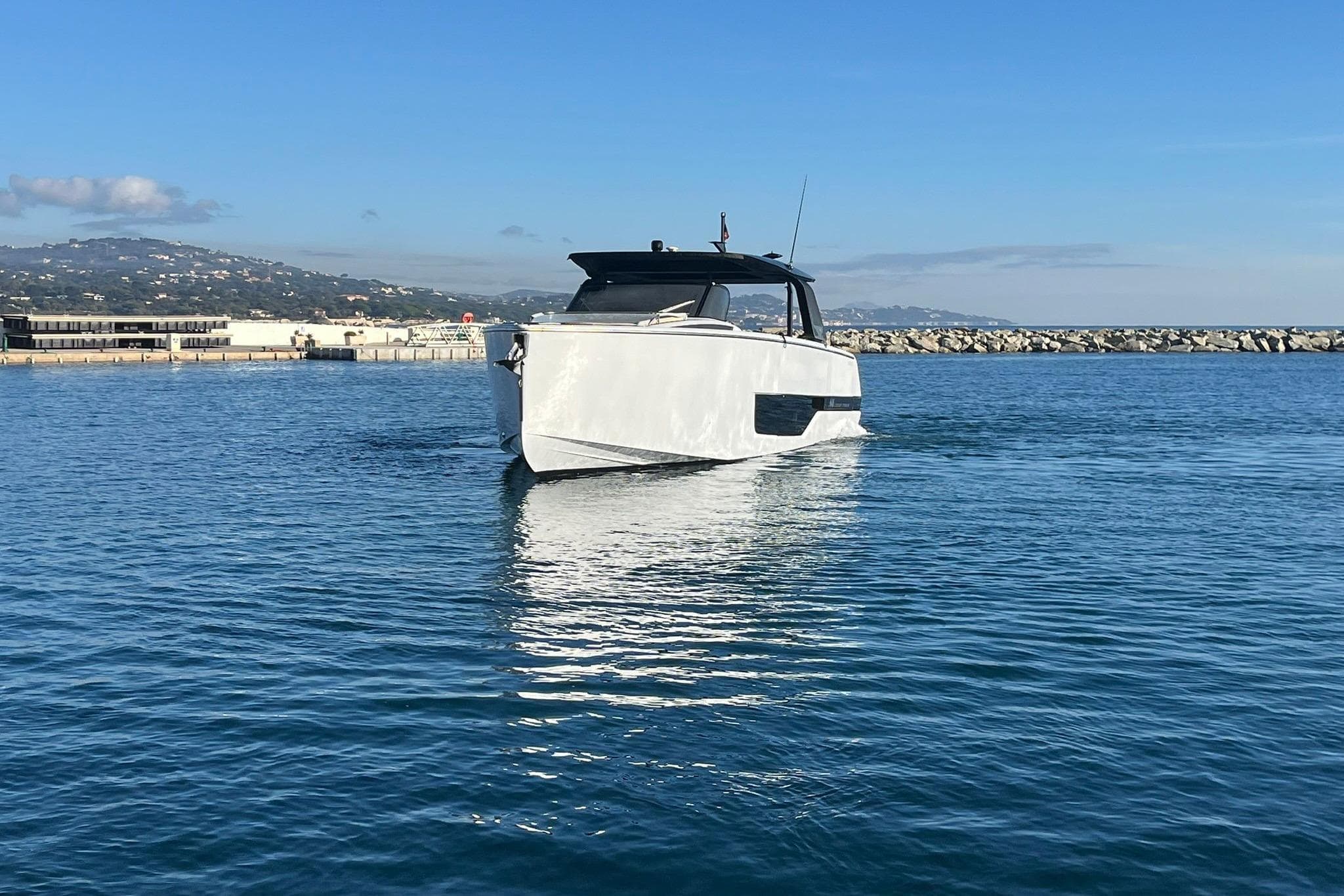 2023 Cranchi A46 Luxury Tender yacht on calm blue water, scenic coastal backdrop.