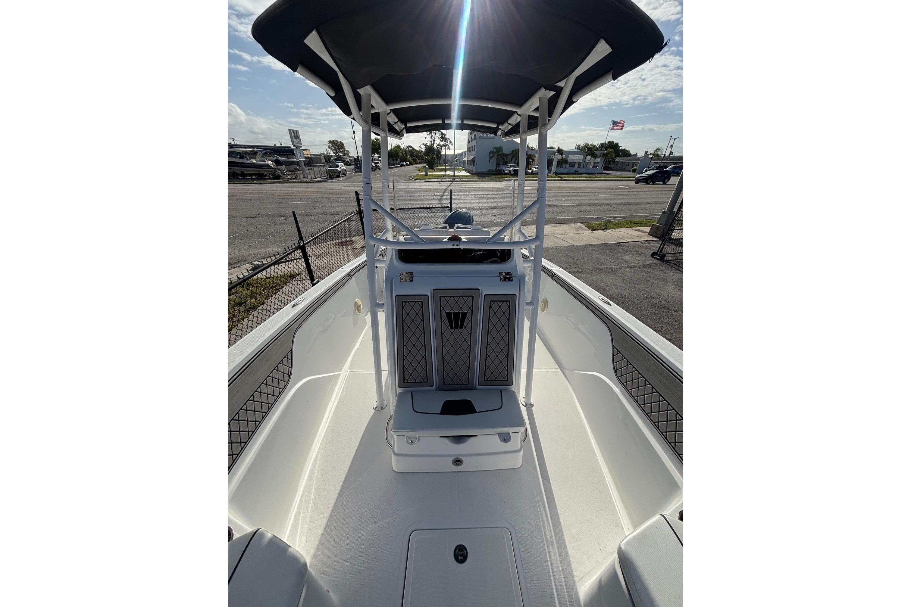 2024 Wellcraft 202 Fisherman boat interior with T-top and spacious deck.