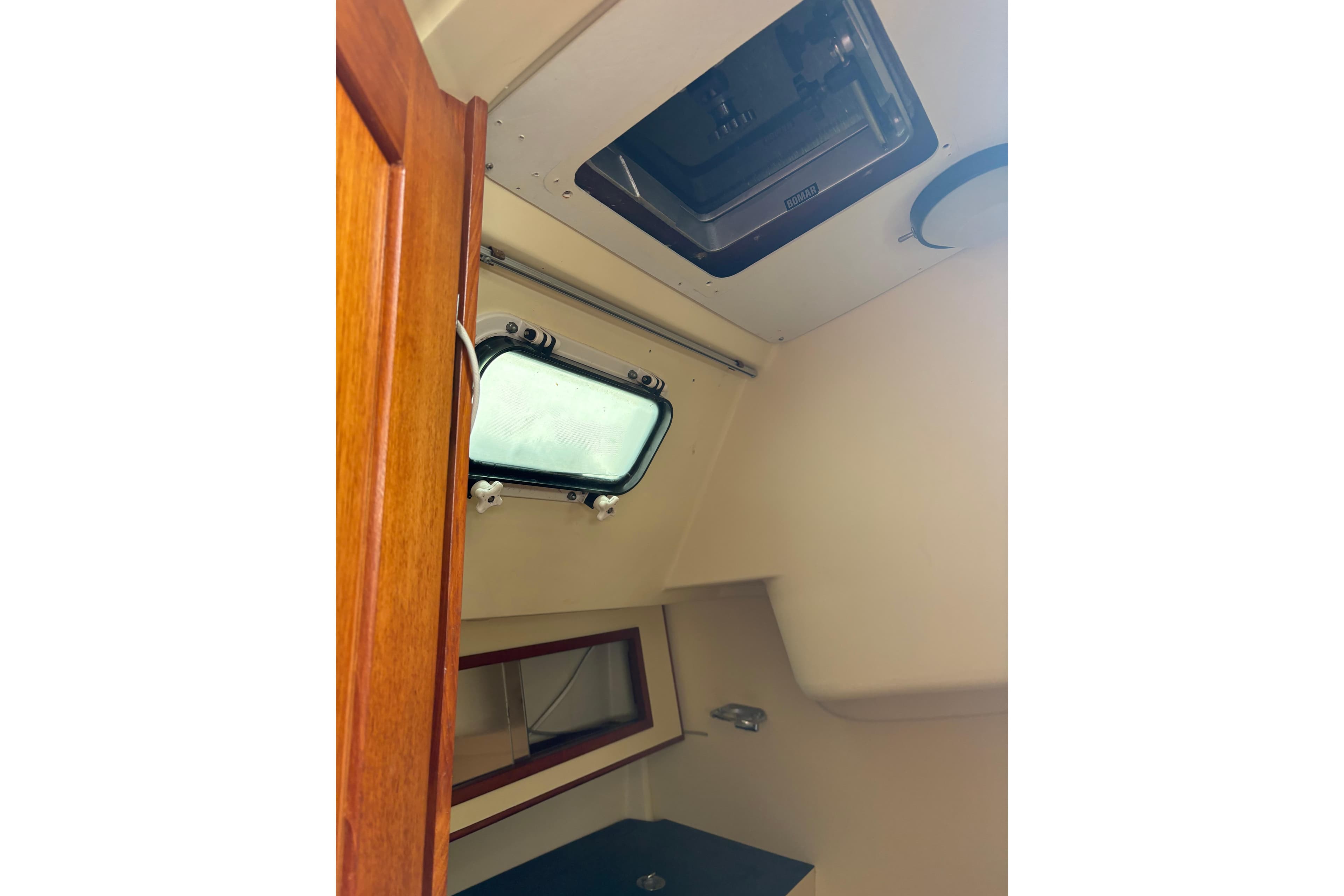 Interior cabin view of a 1988 Pearson 28 sailboat, featuring a window and hatch.