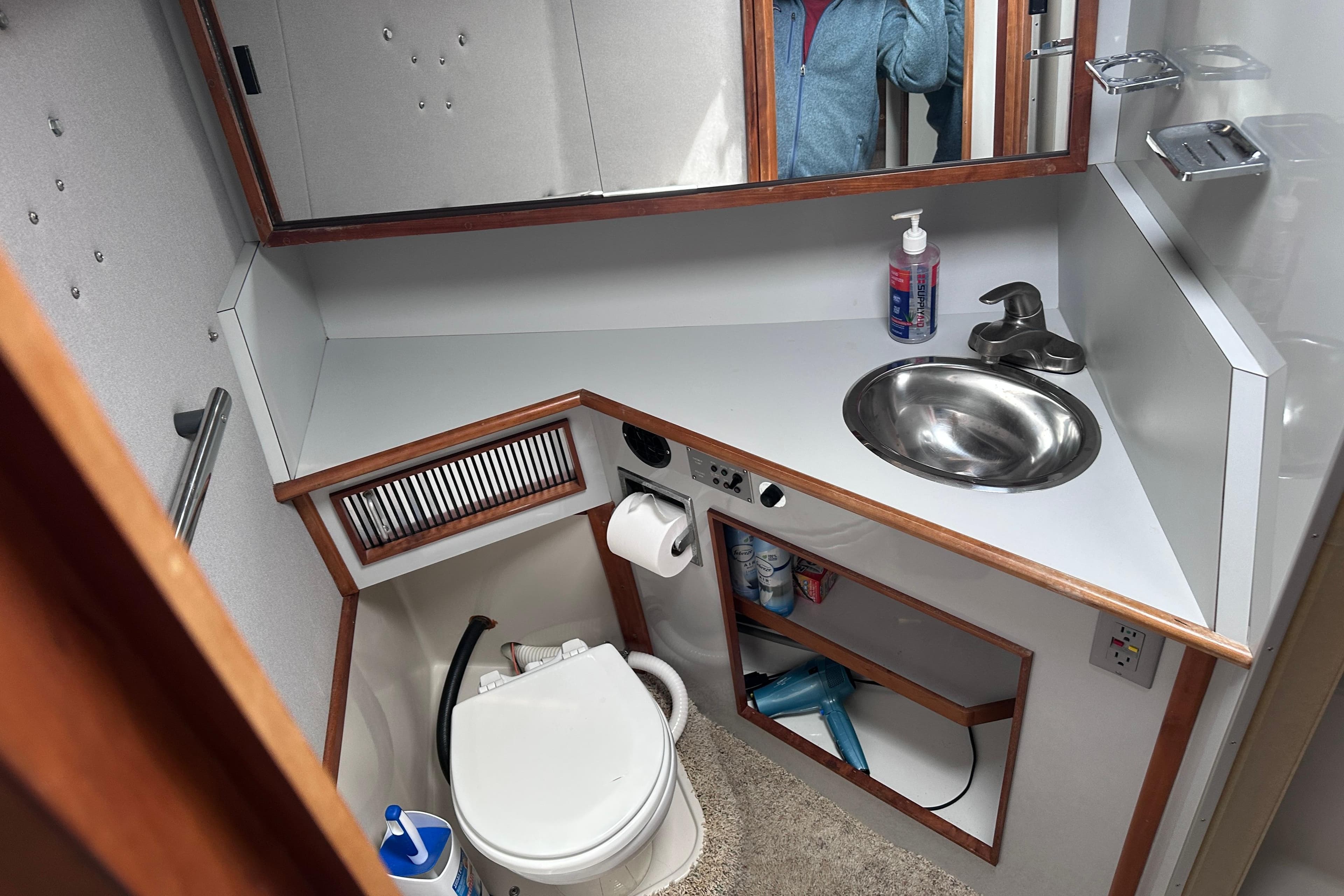 1989 Sea Ray 390 Express Cruiser bathroom with sink, mirror, and toilet.