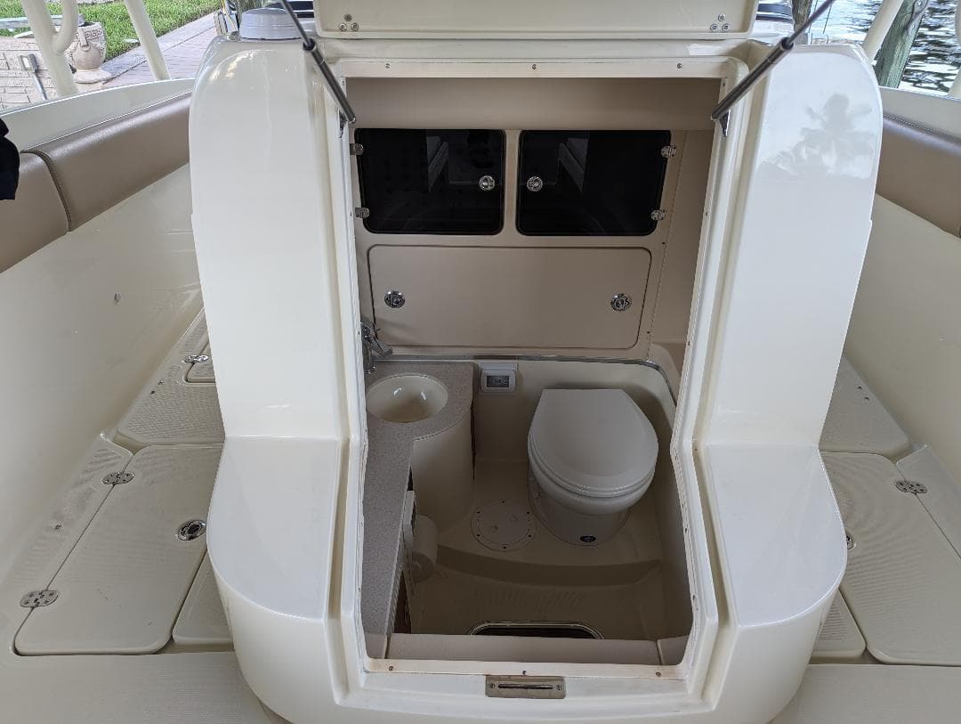 2015 Chris-Craft Catalina 29 boat interior with compact bathroom and toilet.