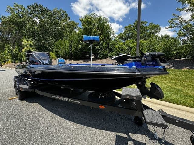 2024 Vexus VXS20 boat on trailer, parked outdoors, featuring Garmin equipment.