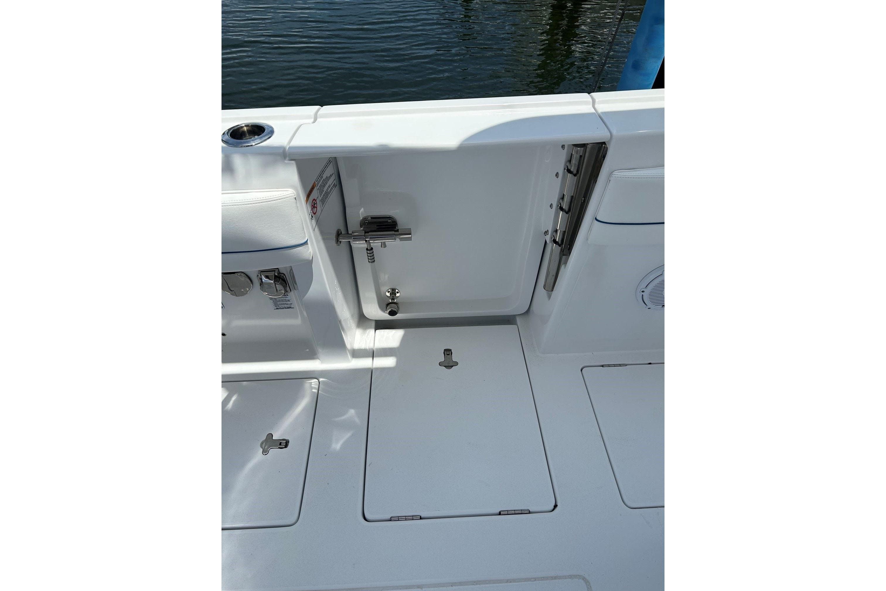 2025 Intrepid 375 Nomad SE boat deck with open hatch and water view.