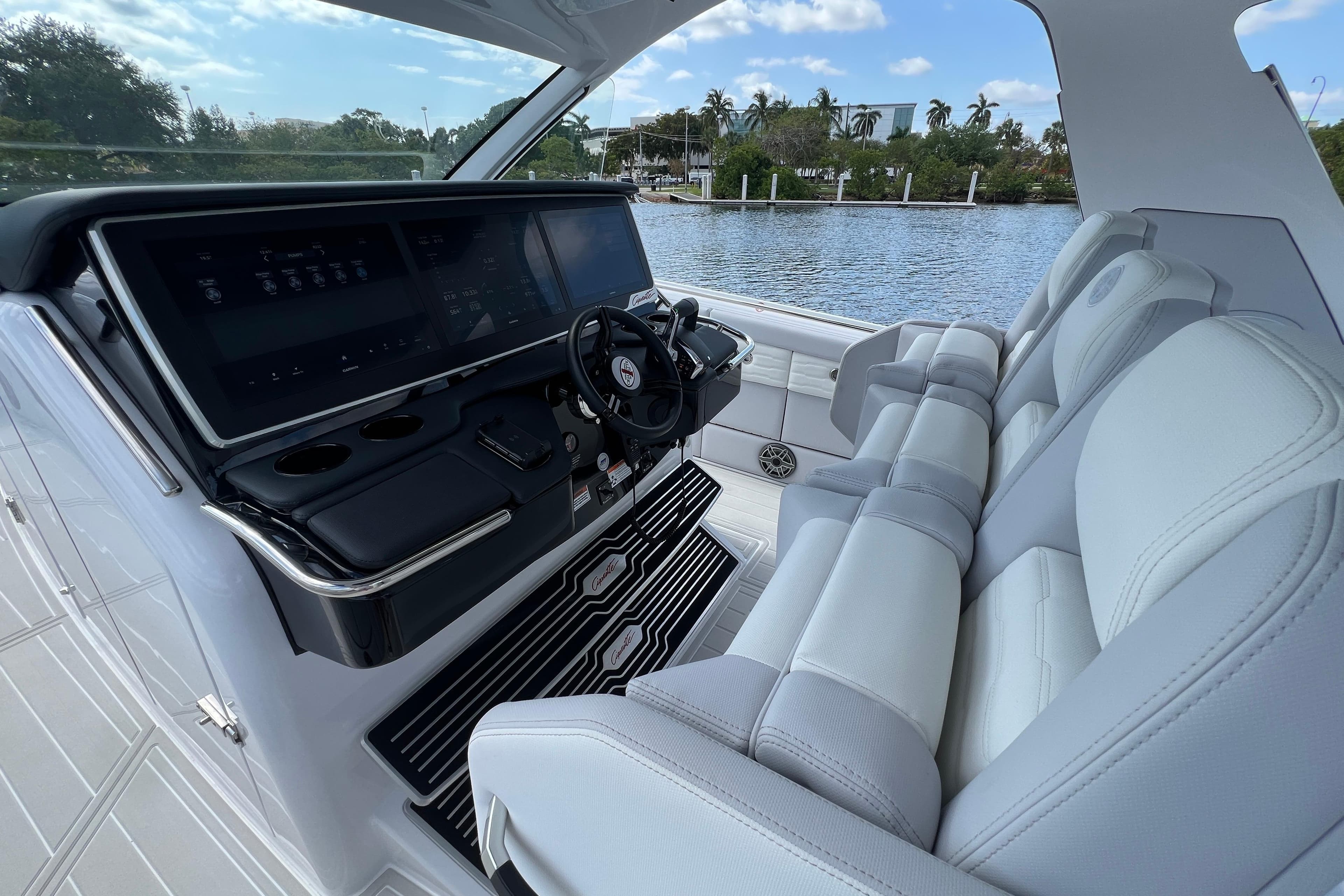 Interior of 2025 Cigarette 41 Nighthawk boat with modern dashboard and luxurious seating.
