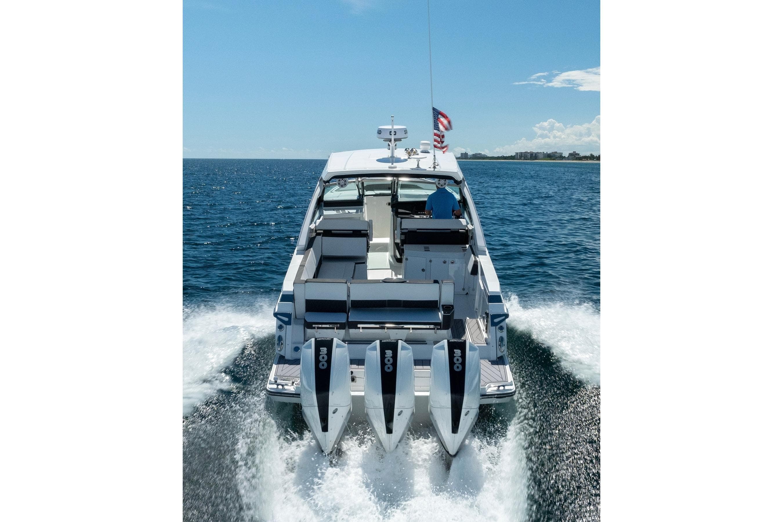 2026 Monterey 385SS Super Sport boat cruising on open water, rear view.