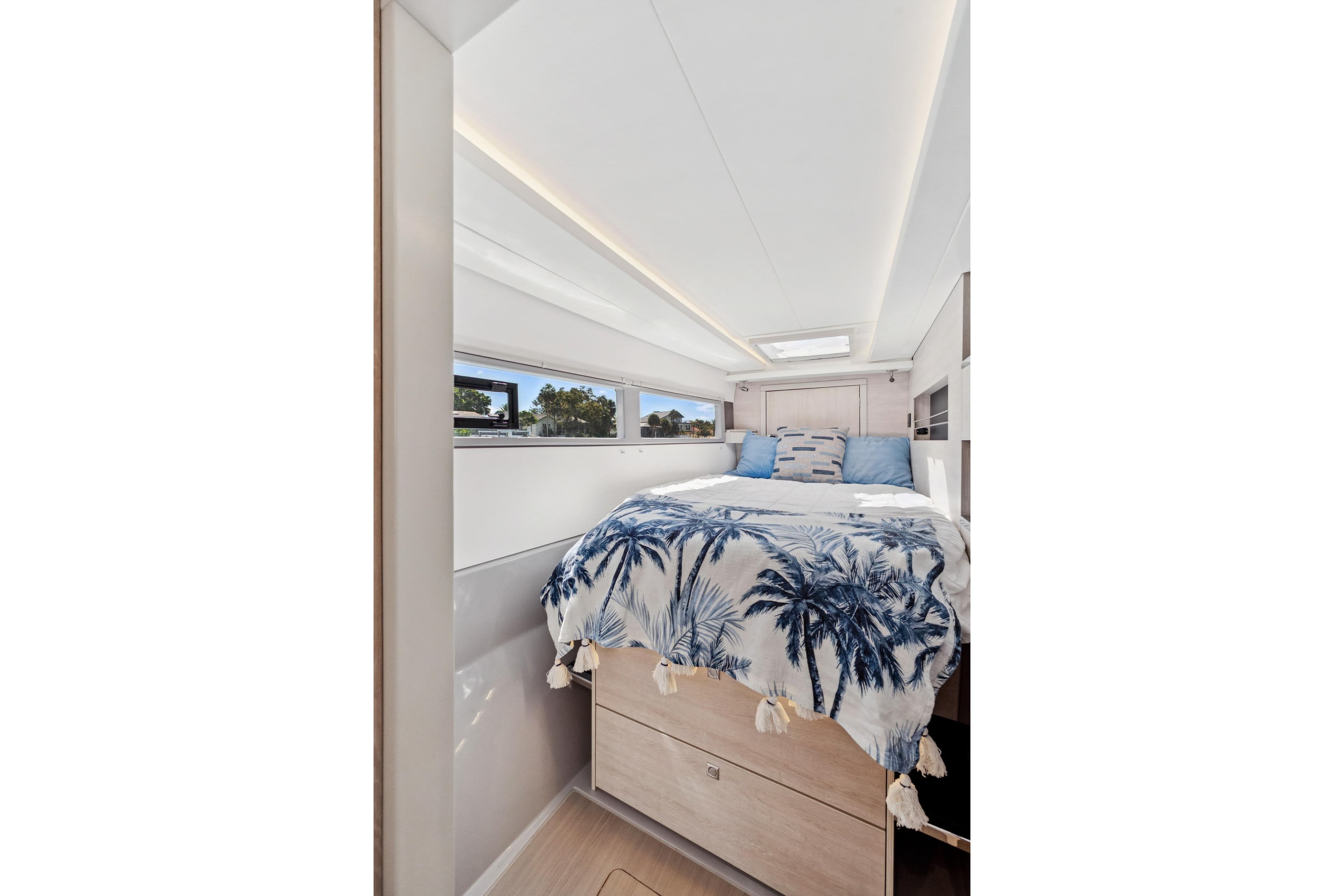 Luxurious bedroom interior of 2021 Leopard 45 yacht with tropical-themed bedding.