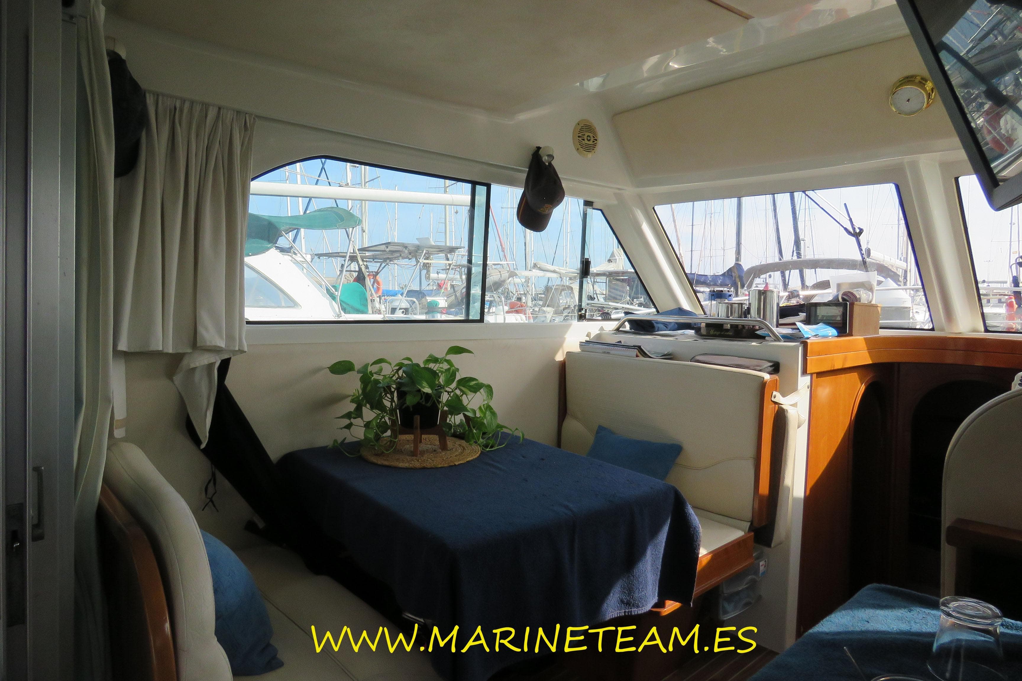Interior of 2005 Starfisher 1060 boat with dining area and marina view.