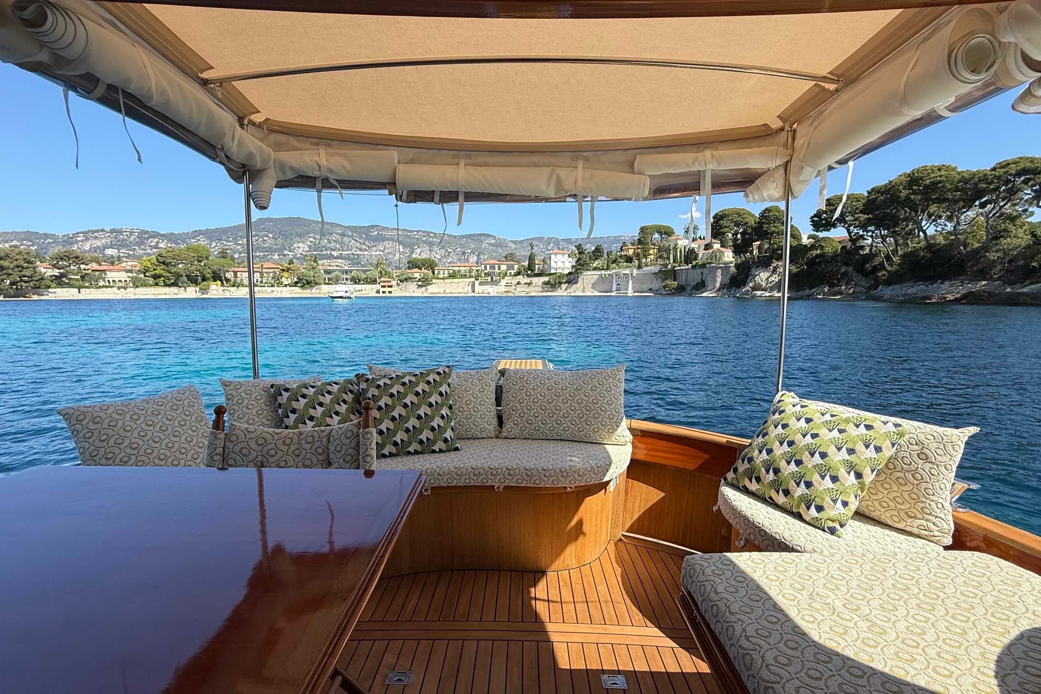 Luxurious 2009 Bani 11,50 Prestige yacht with elegant seating, scenic coastal view.