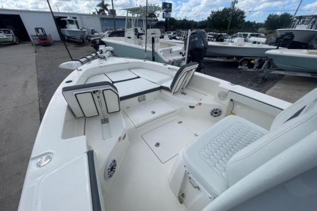 2026 Pathfinder 2600 TRS boat interior with seating and storage, docked at a marina.