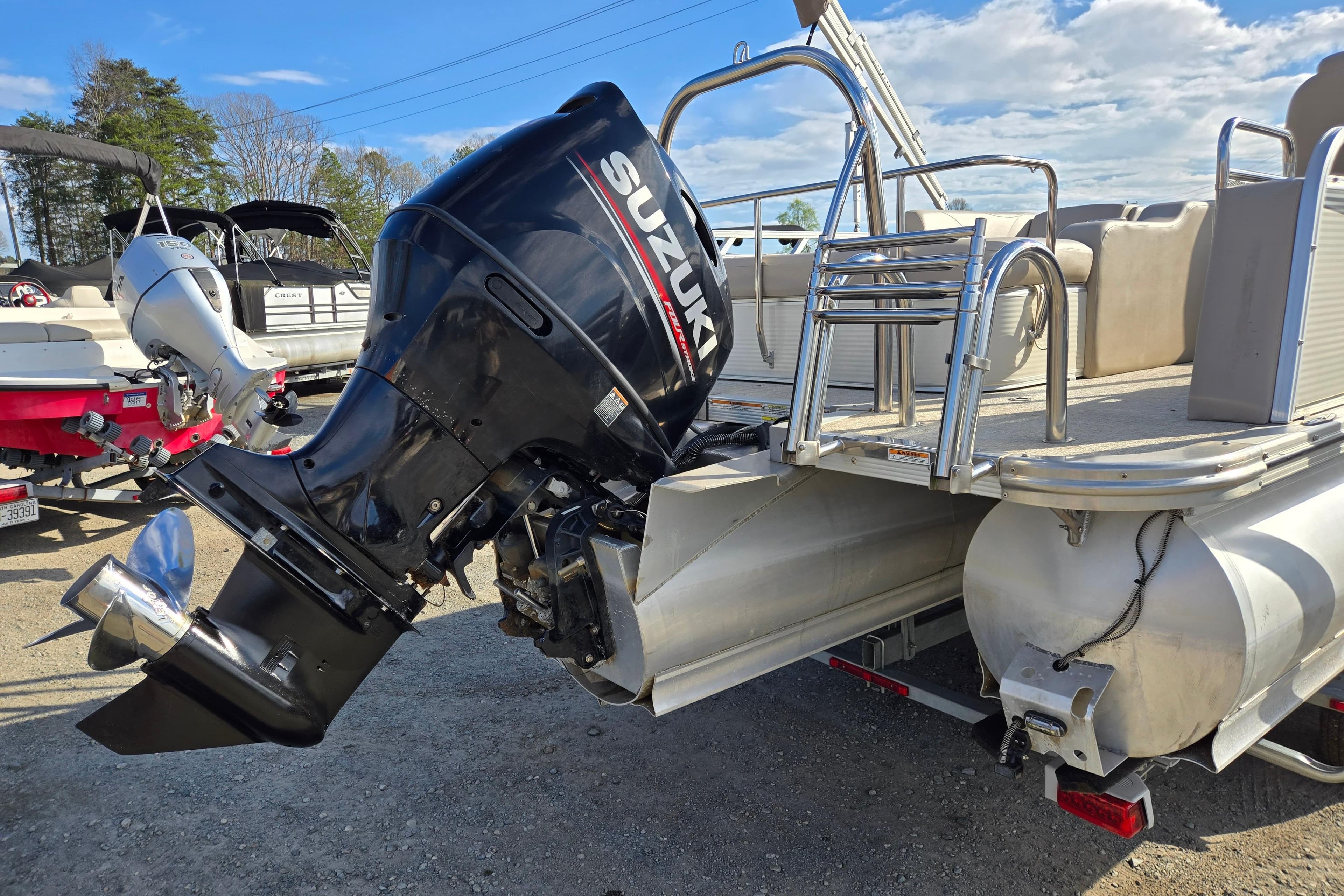 2020 Avalon LSZ VRB 24' pontoon boat with Suzuki outboard motor, parked outdoors.