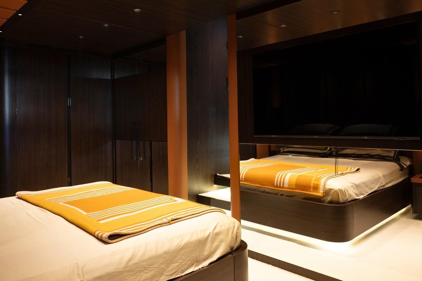 Luxurious bedroom interior on 2008 Magnum 80 yacht, featuring modern design and ambient lighting.