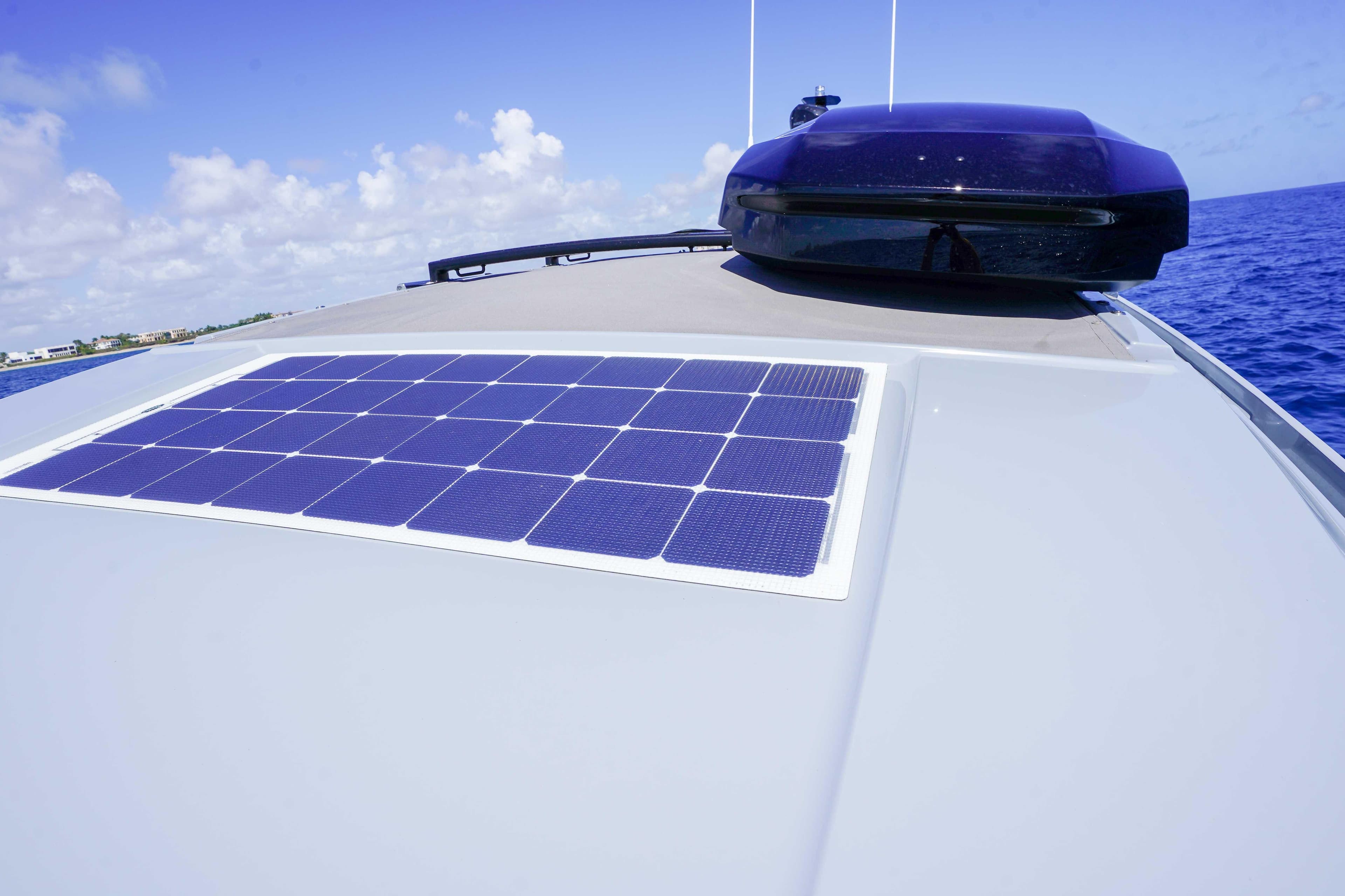 2024 Axopar 37 XC Cross Cabin with solar panel on deck, cruising on open sea.