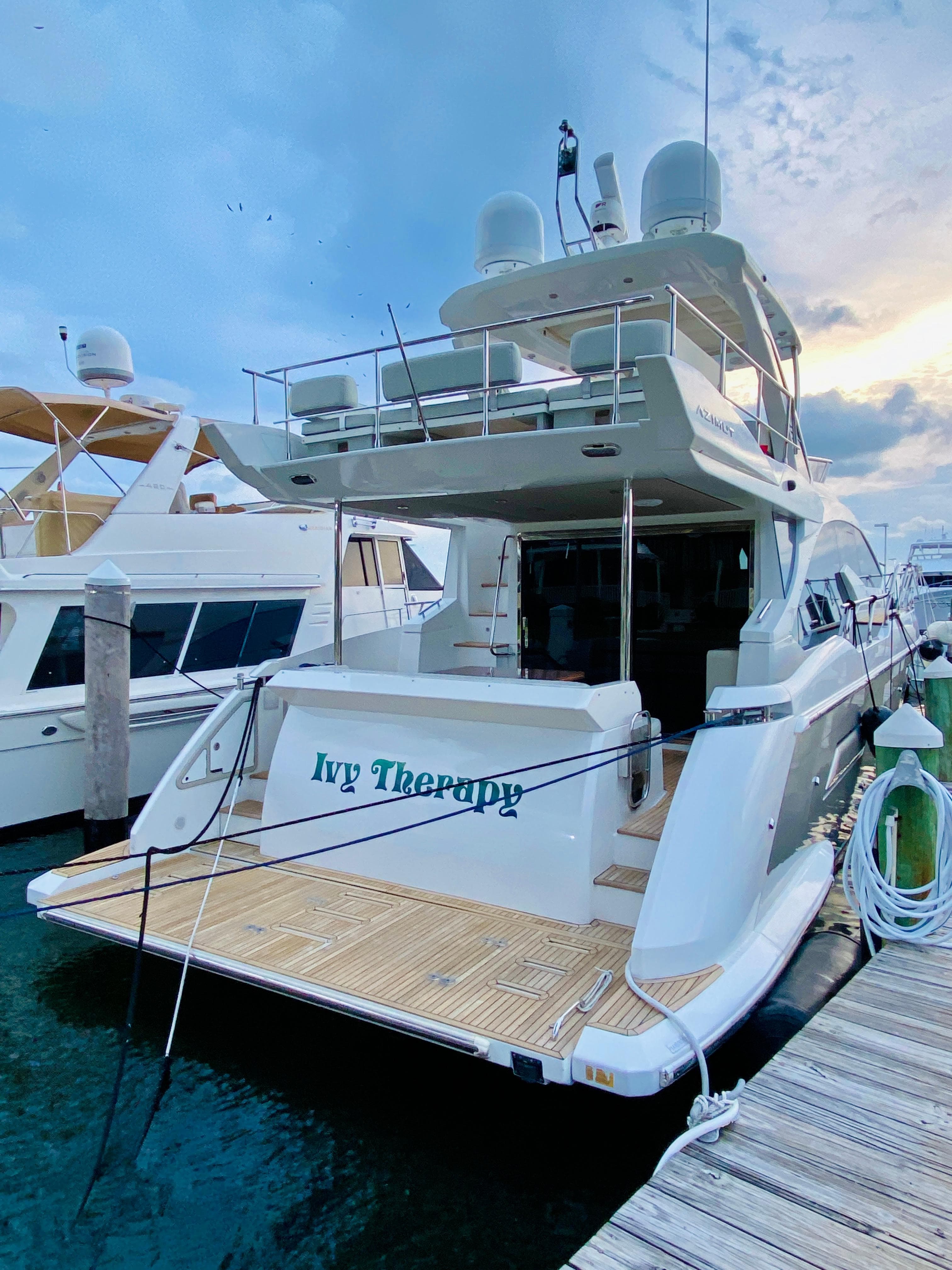2015 Azimut 50 yacht docked at marina, named "Ivy Therapy."